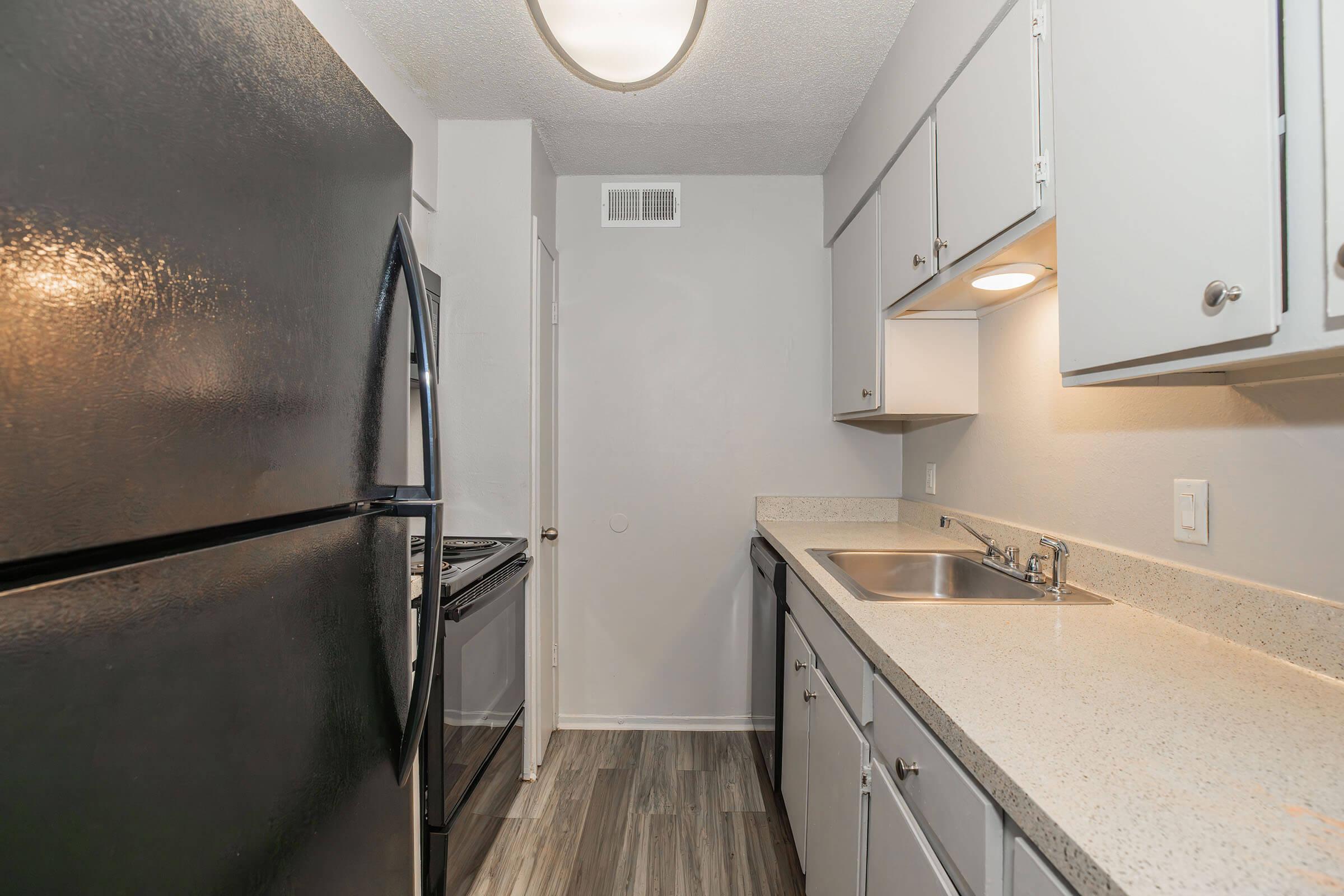 a kitchen with a sink and a refrigerator