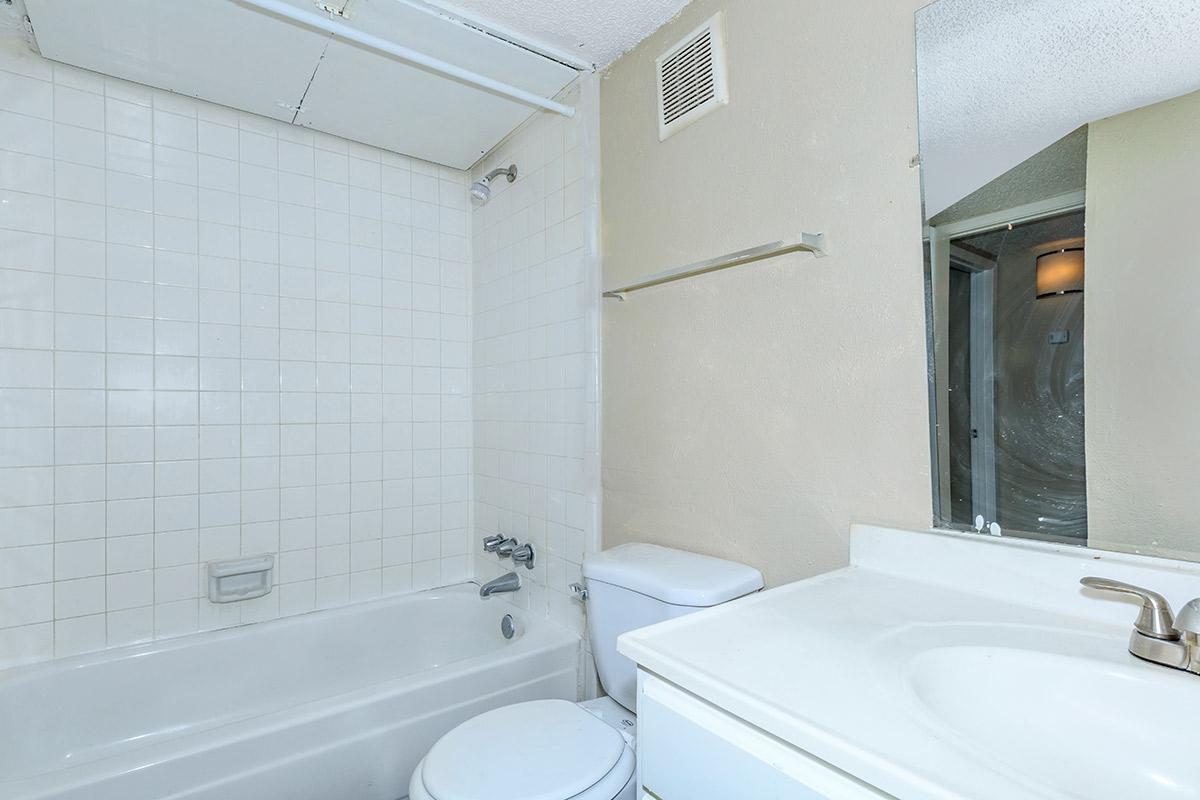 a white tub sitting next to a sink