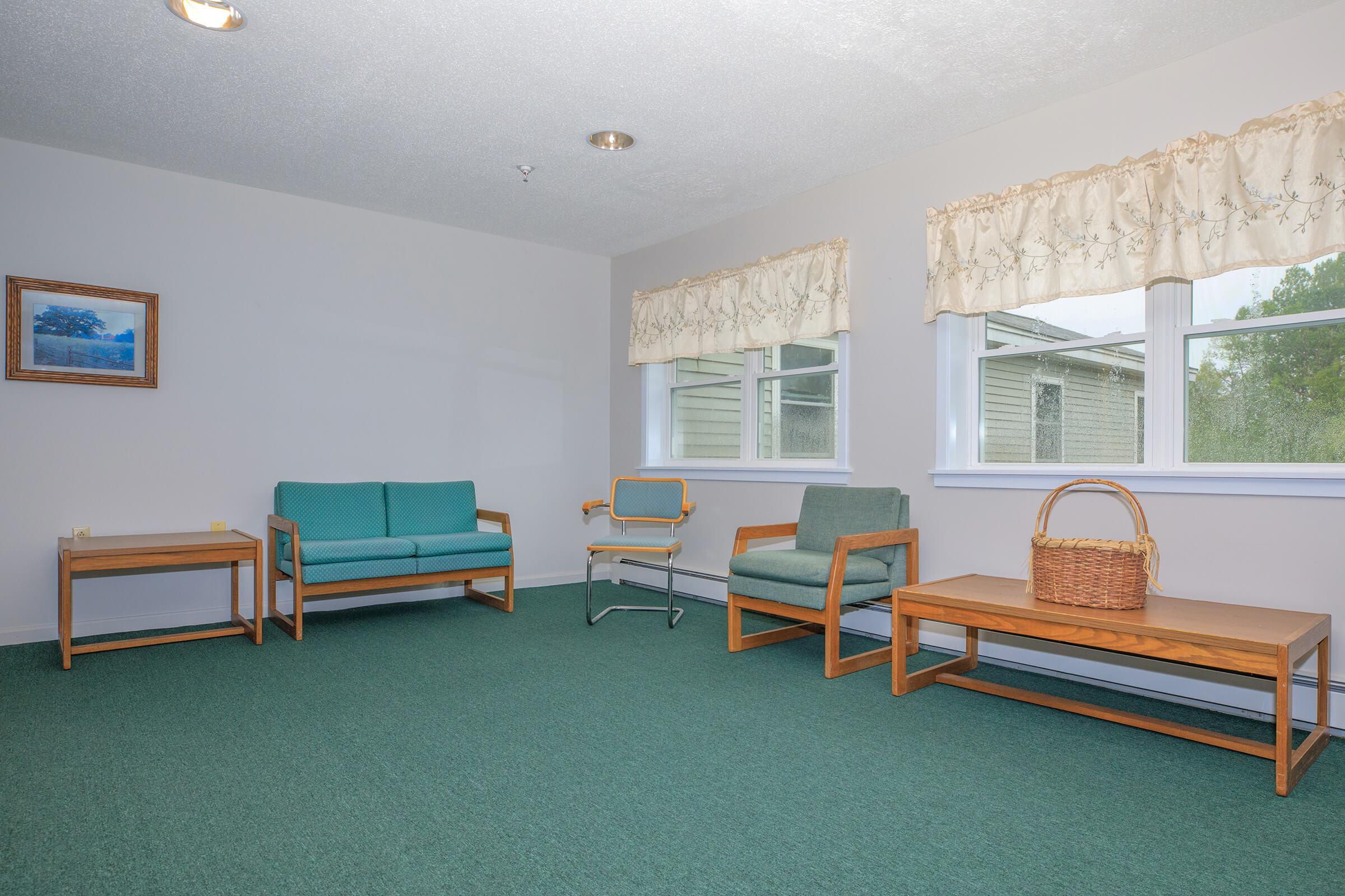 a living room filled with furniture and a large window