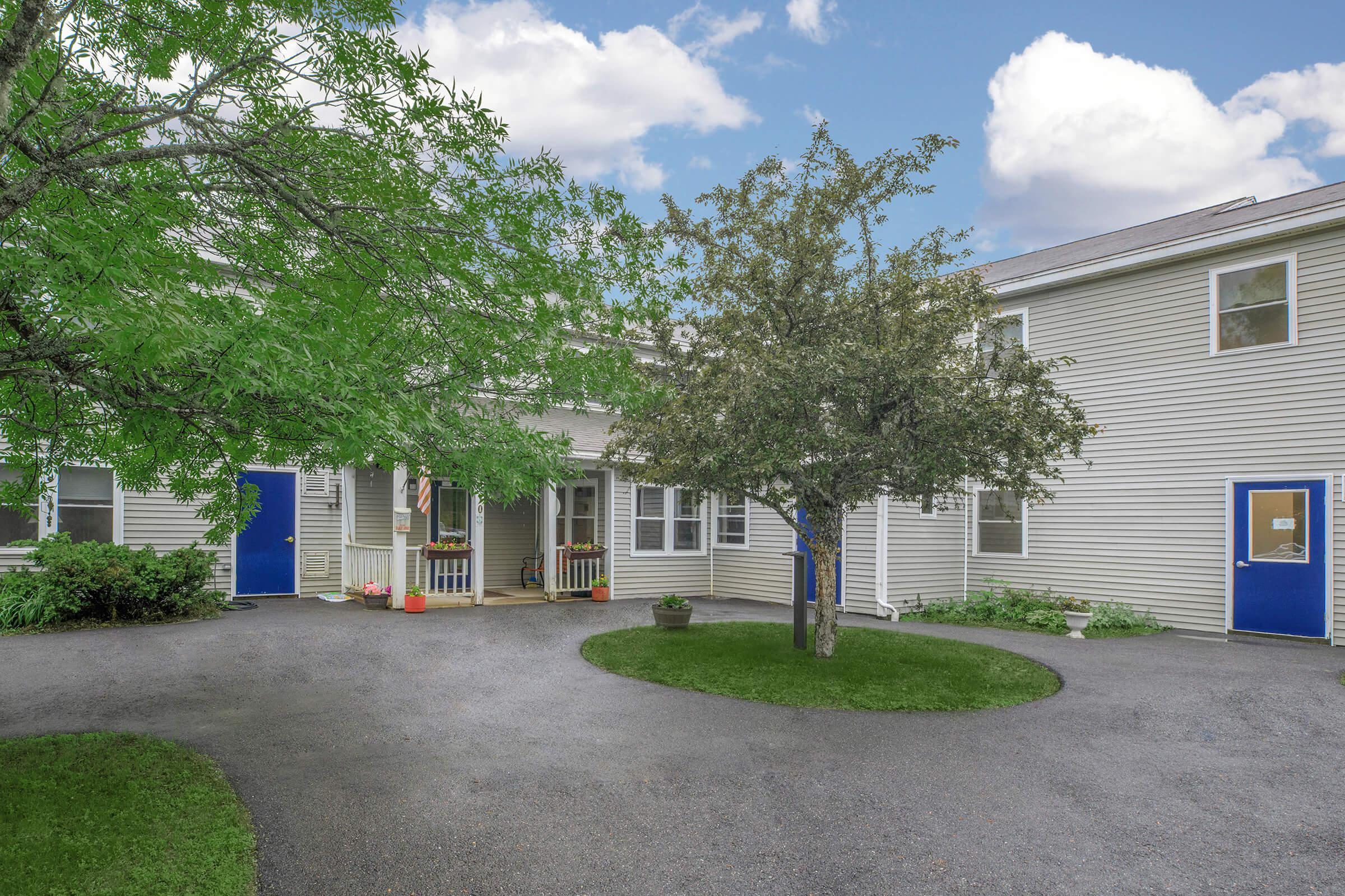 a tree in front of a house