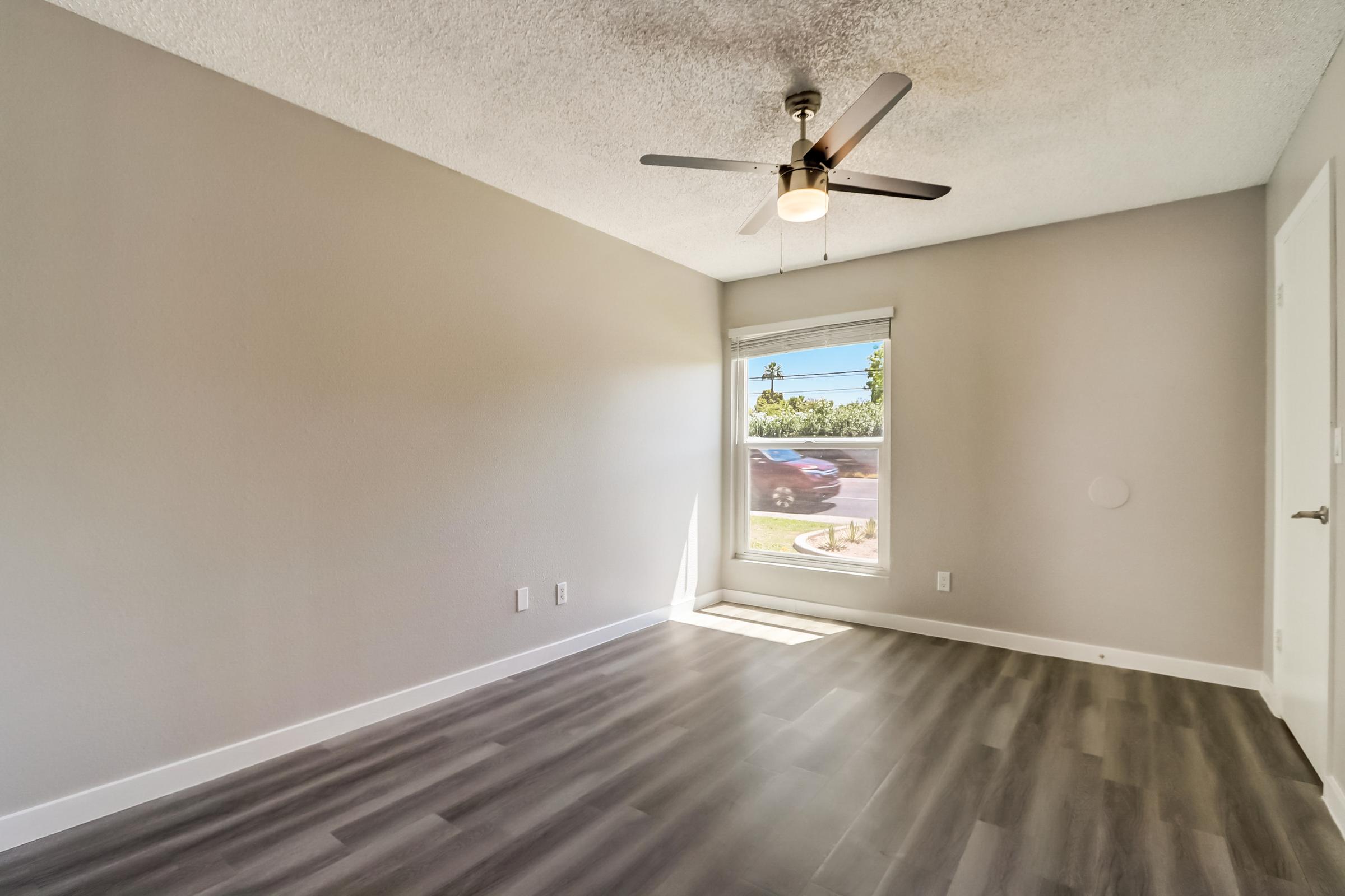 A large bedroom with a window at Rise at the Lofts.