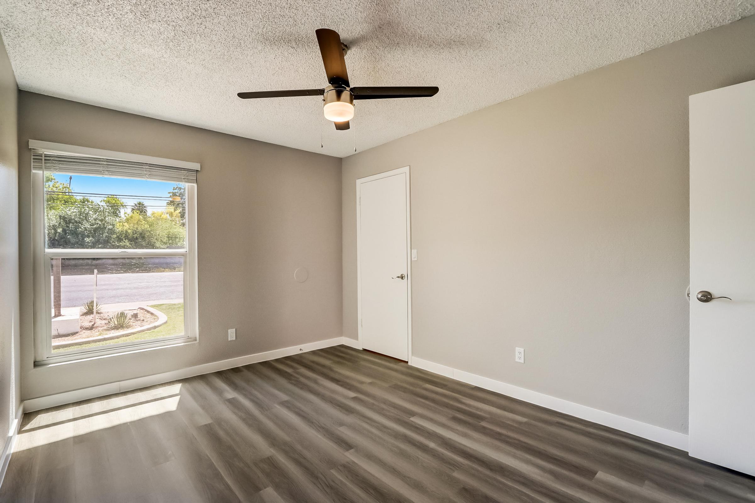 A Rise at the Lofts apartment living room with a wooden floor and window.