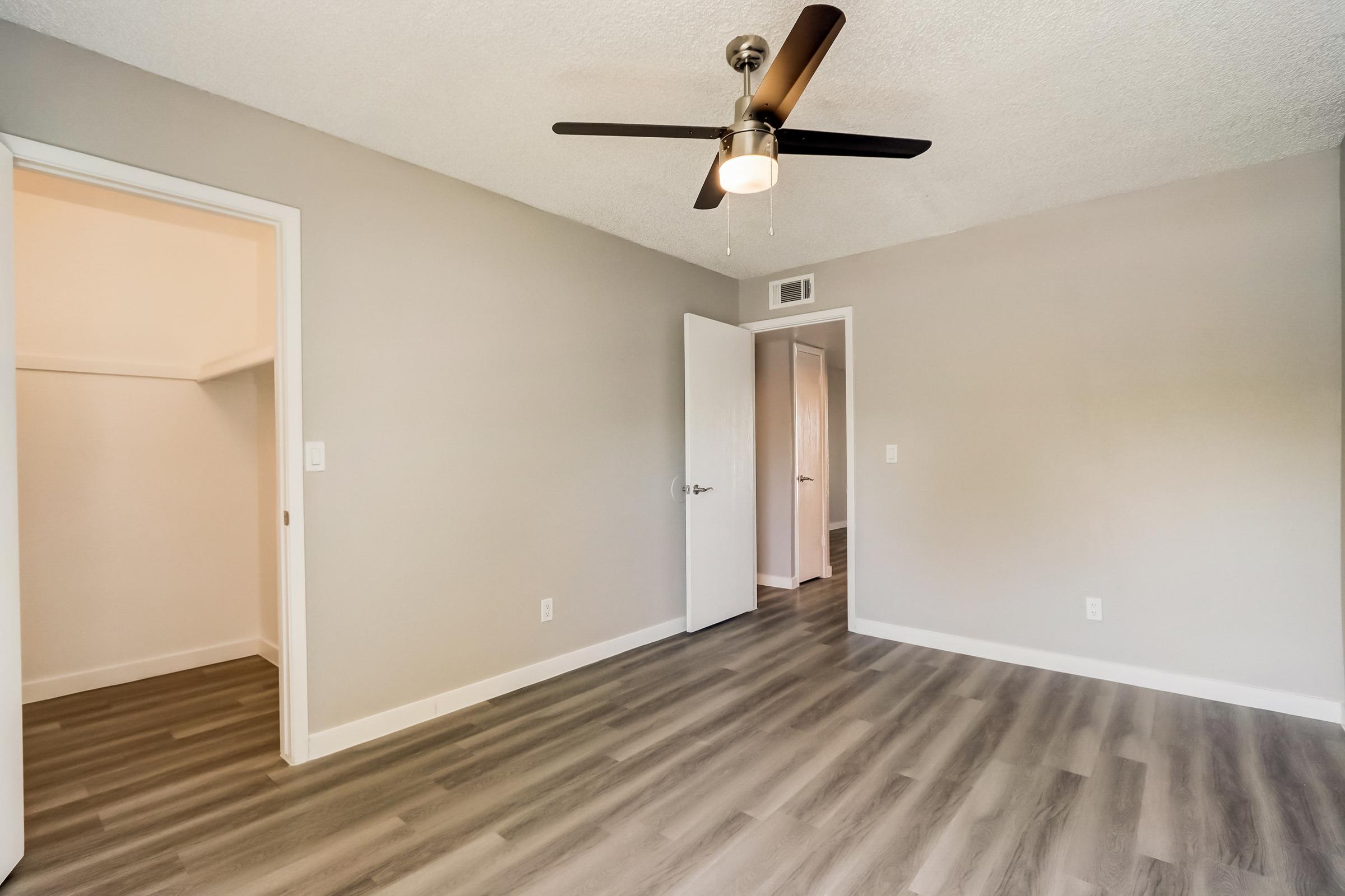 A bedroom with a closet at Rise at the Lofts. 