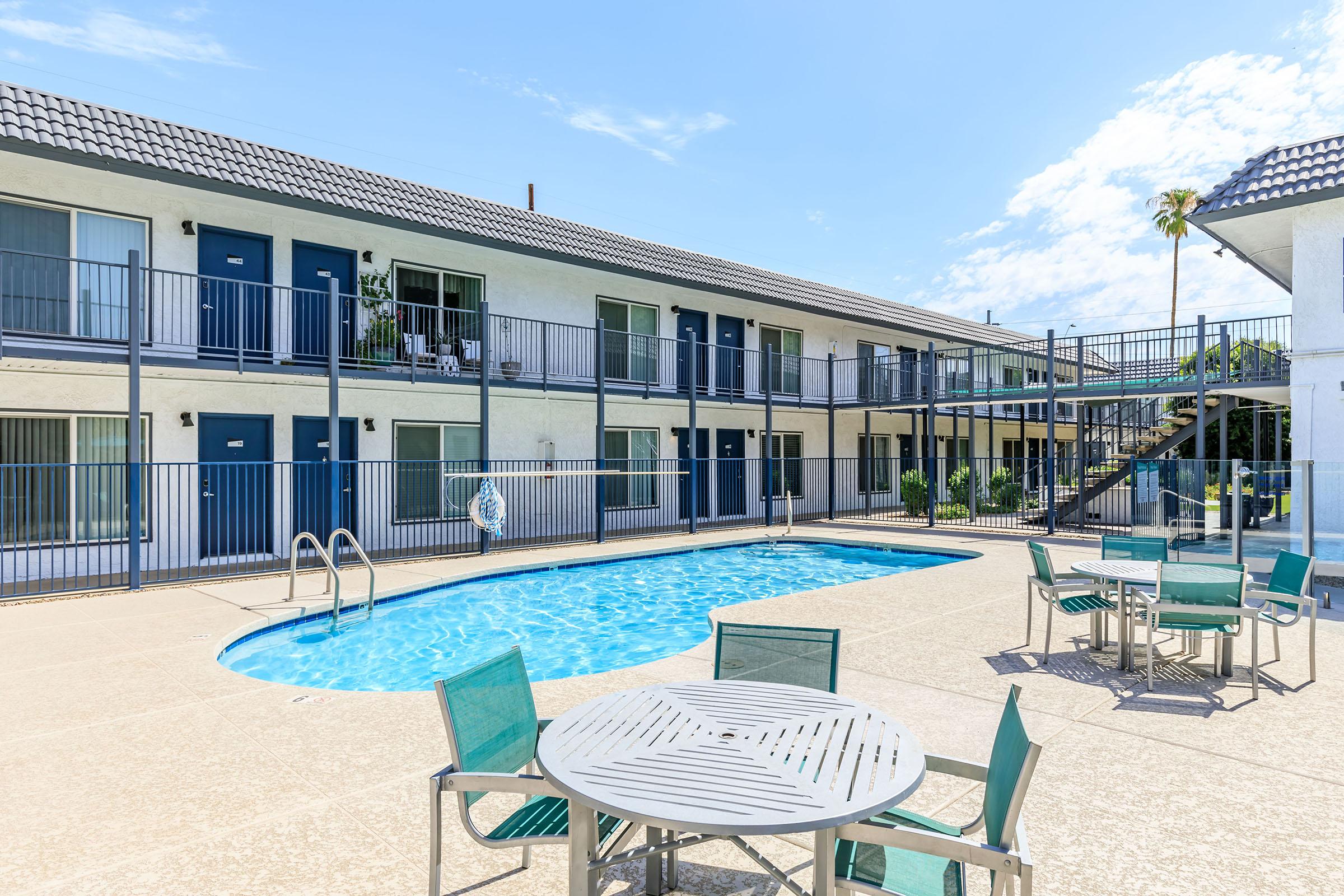 Rise at the Lofts' outdoor swimming pool spa area with tables and chairs.