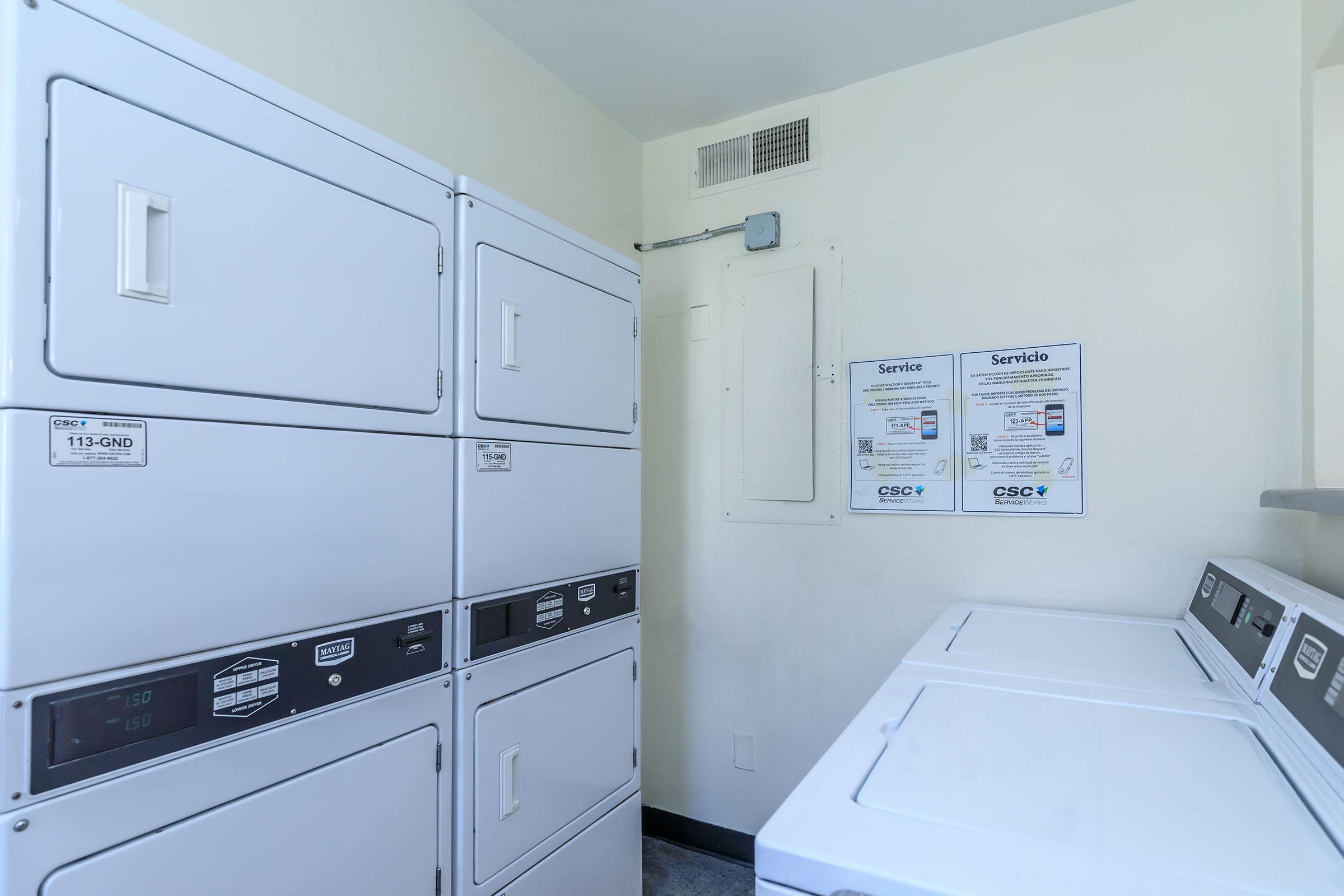 Washer and dryers in laundromat facility at Rise at the Lofts.