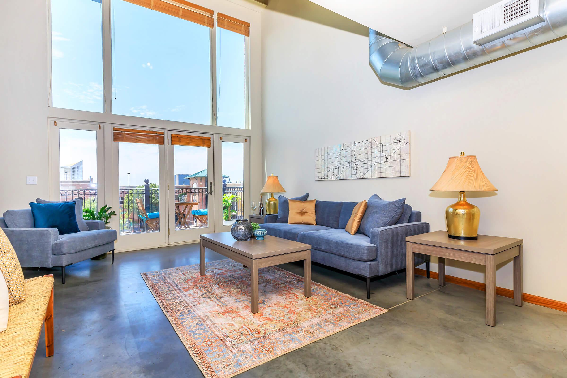 a living room filled with furniture and a large window