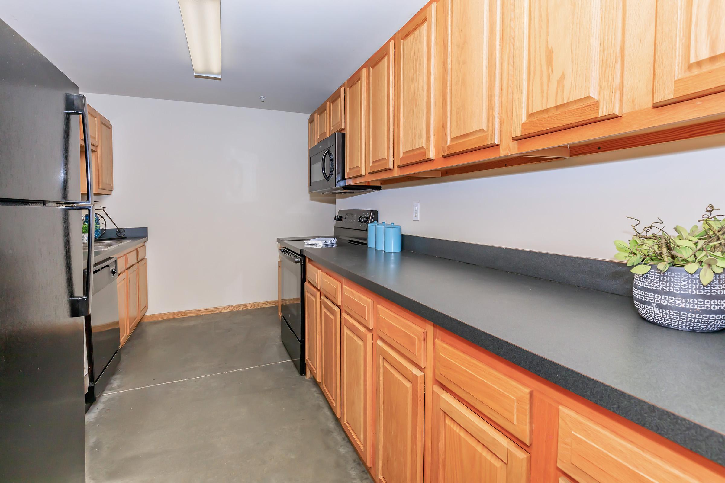 a kitchen with stainless steel appliances and wooden cabinets