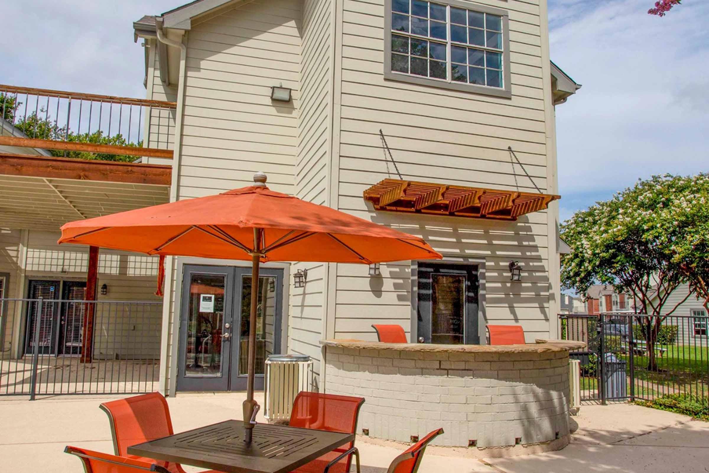 an orange bench in front of a building