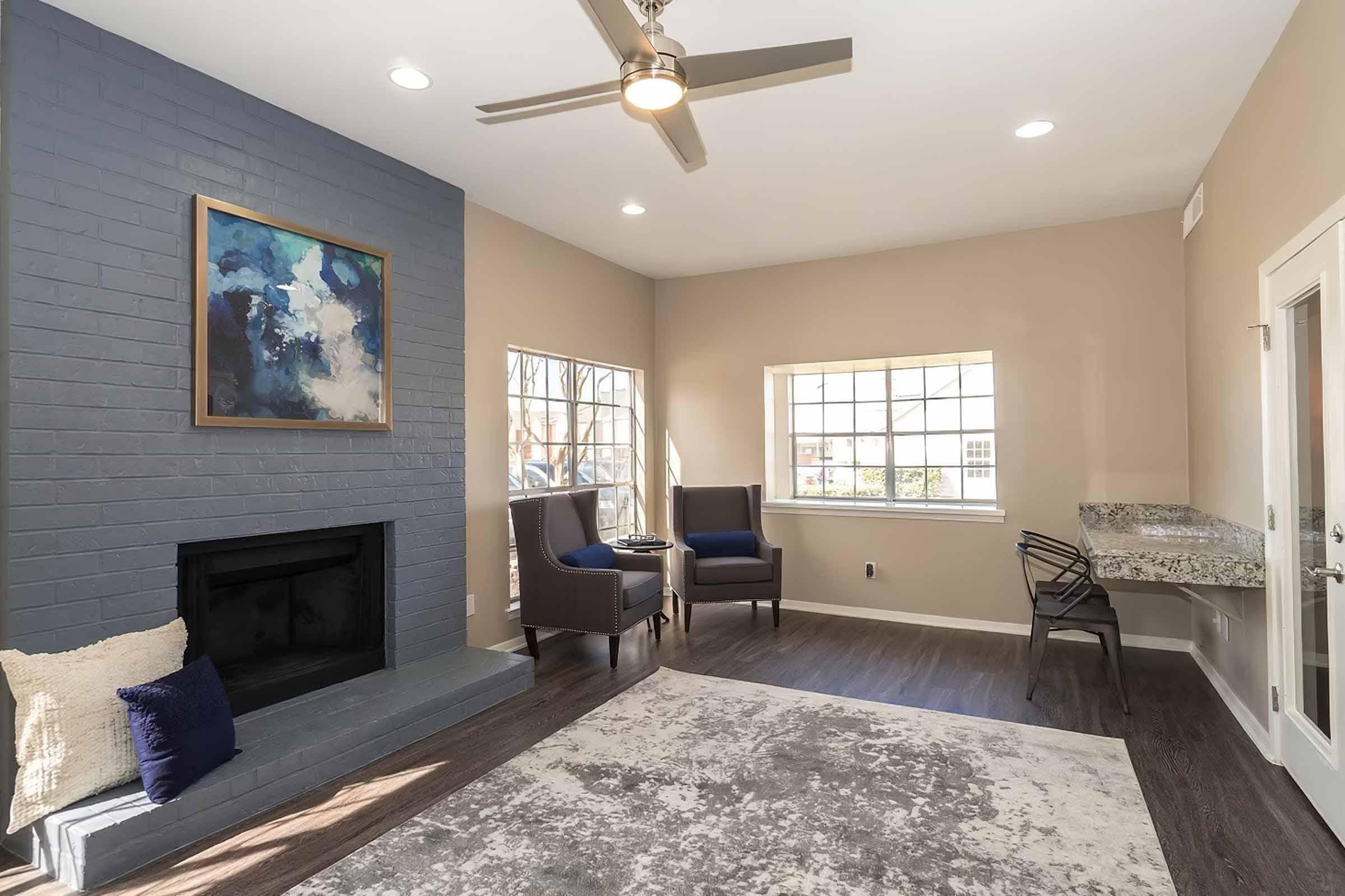 a living room filled with furniture and a large window