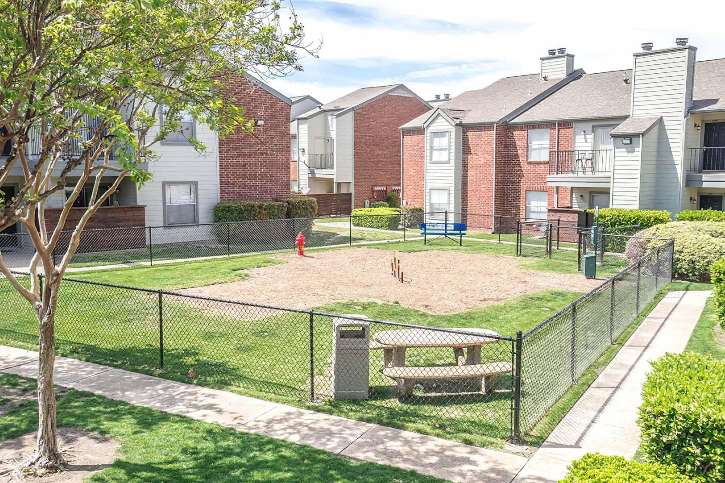 a small house in a fenced in area