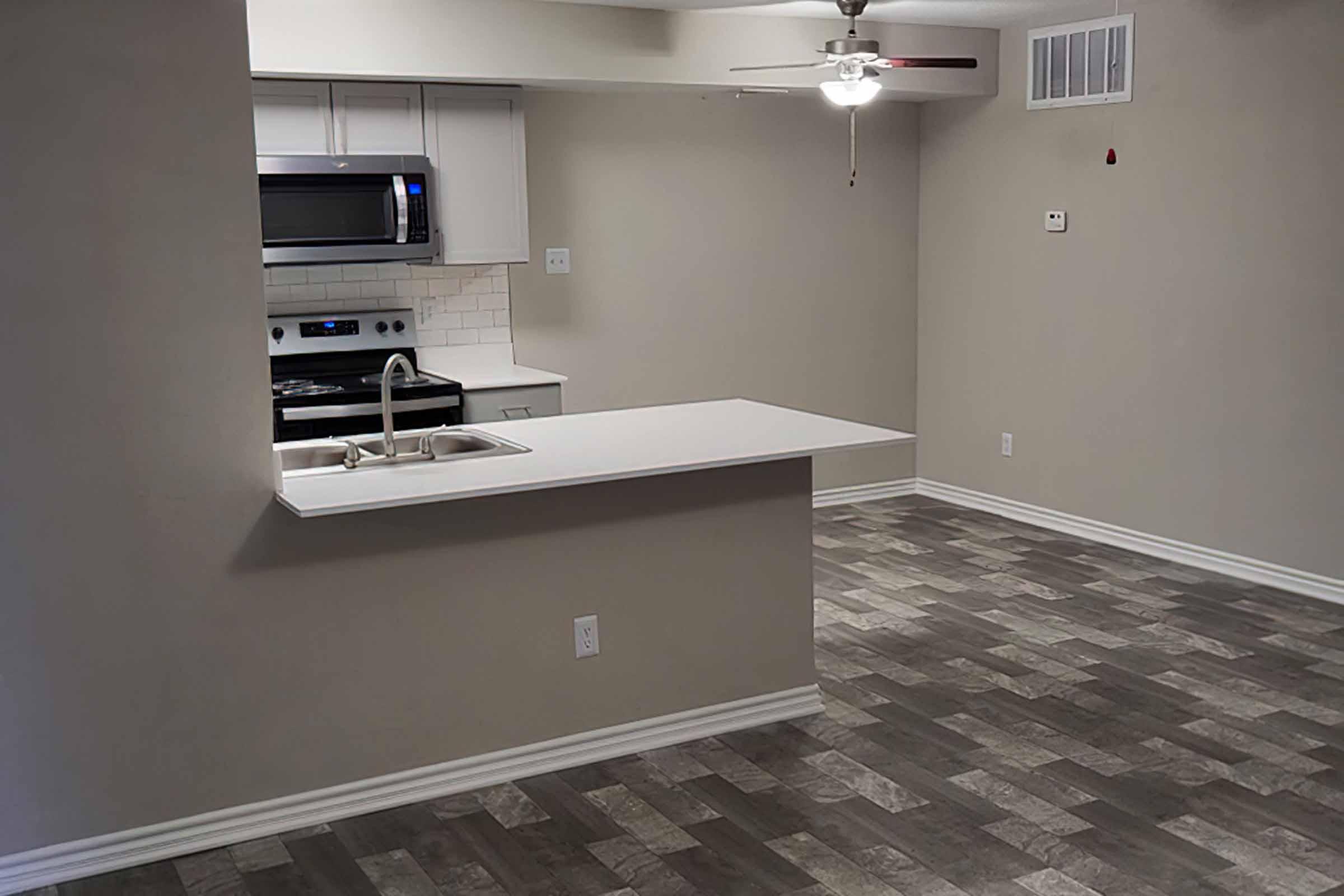 a kitchen with a sink and a refrigerator