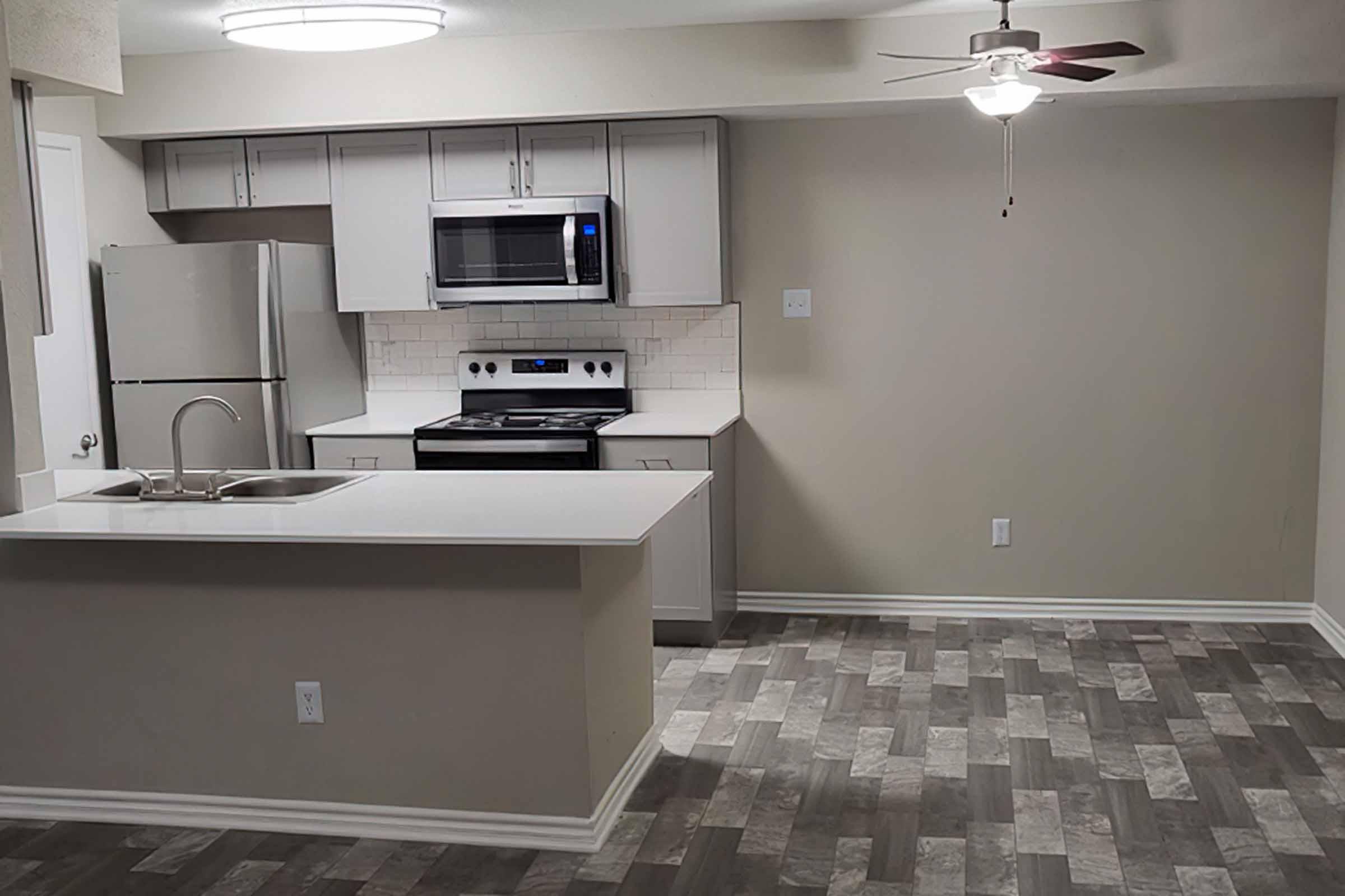 a kitchen with a sink and a microwave