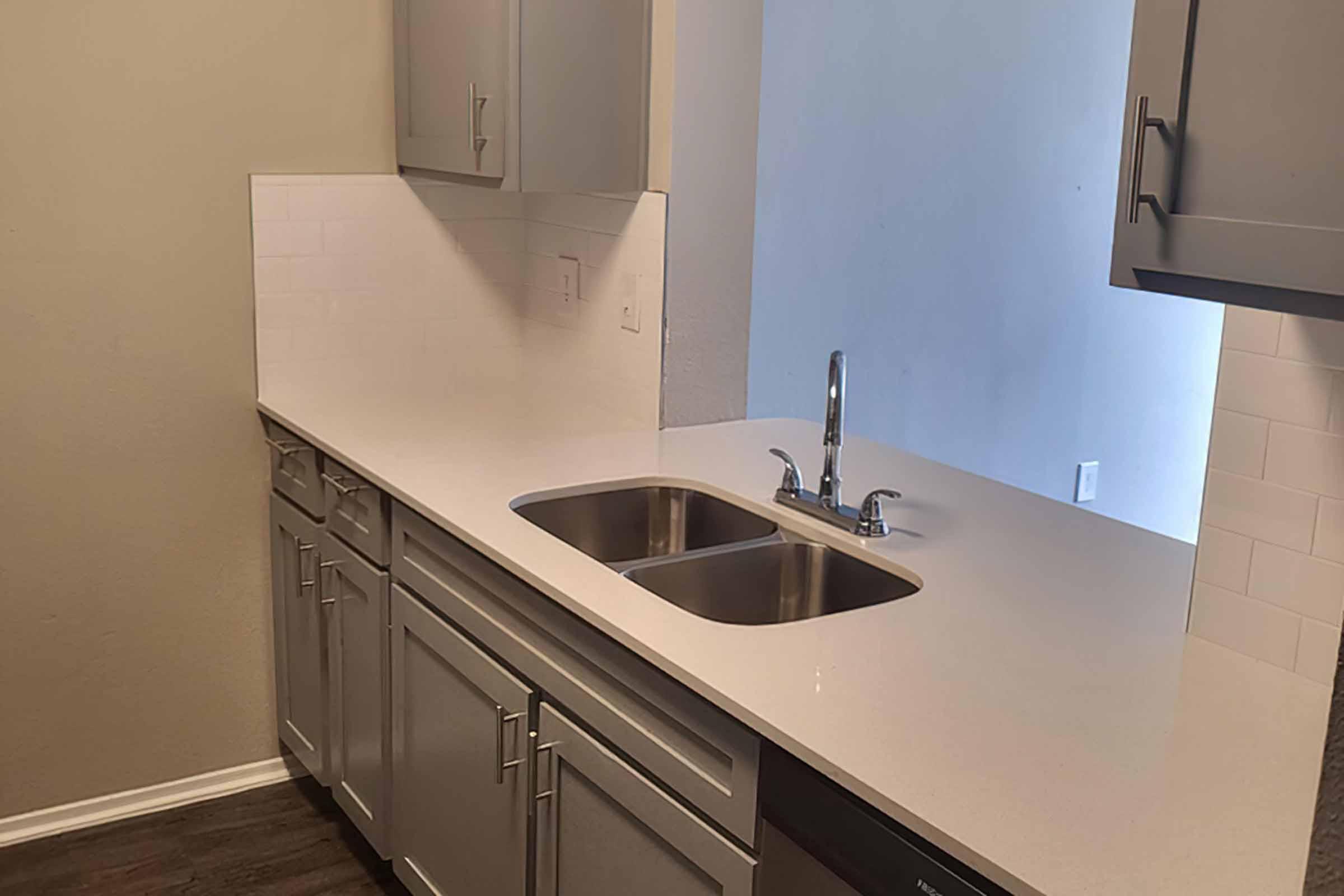 a kitchen with a sink and a refrigerator