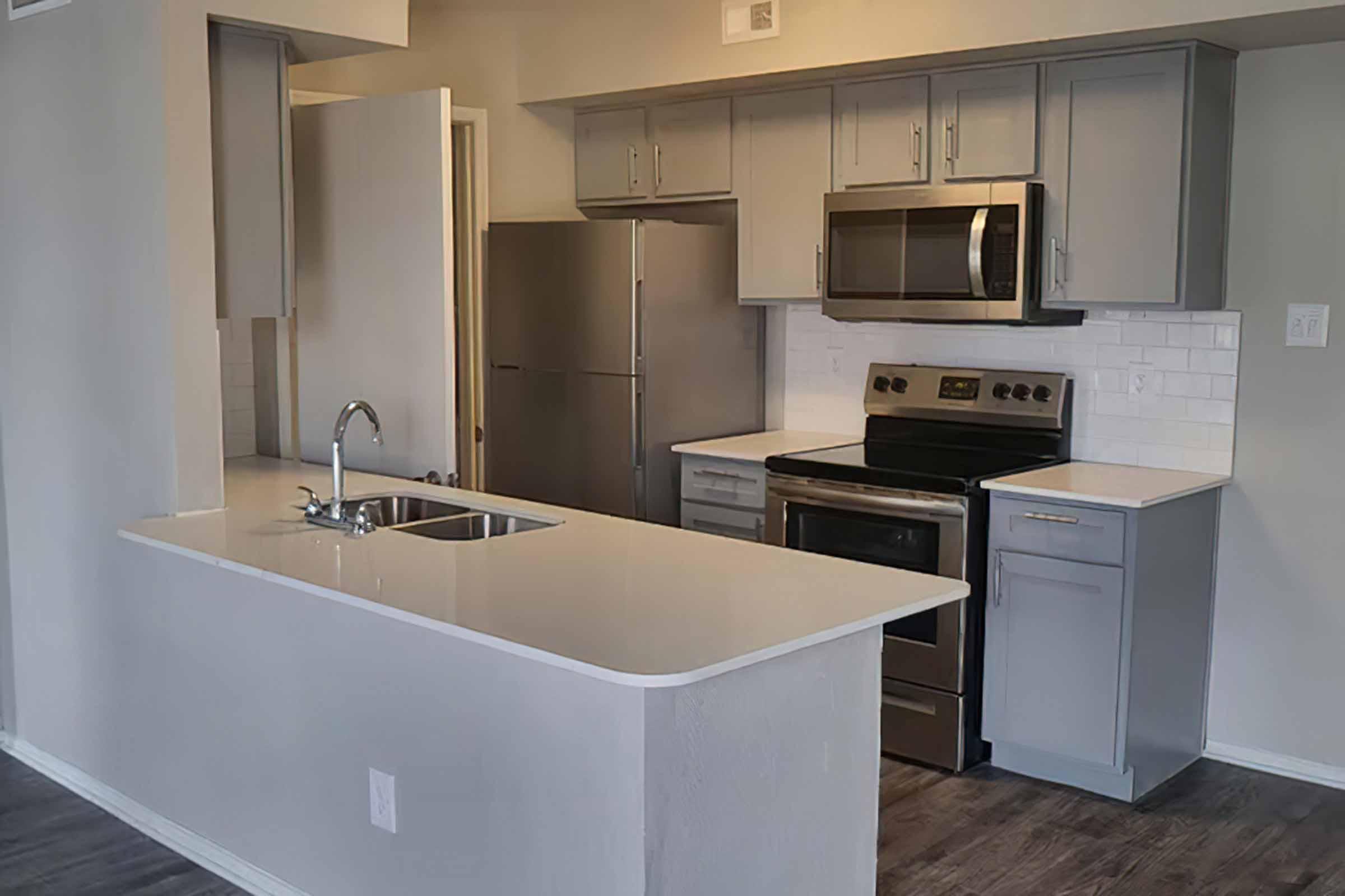 a kitchen with a sink and a mirror