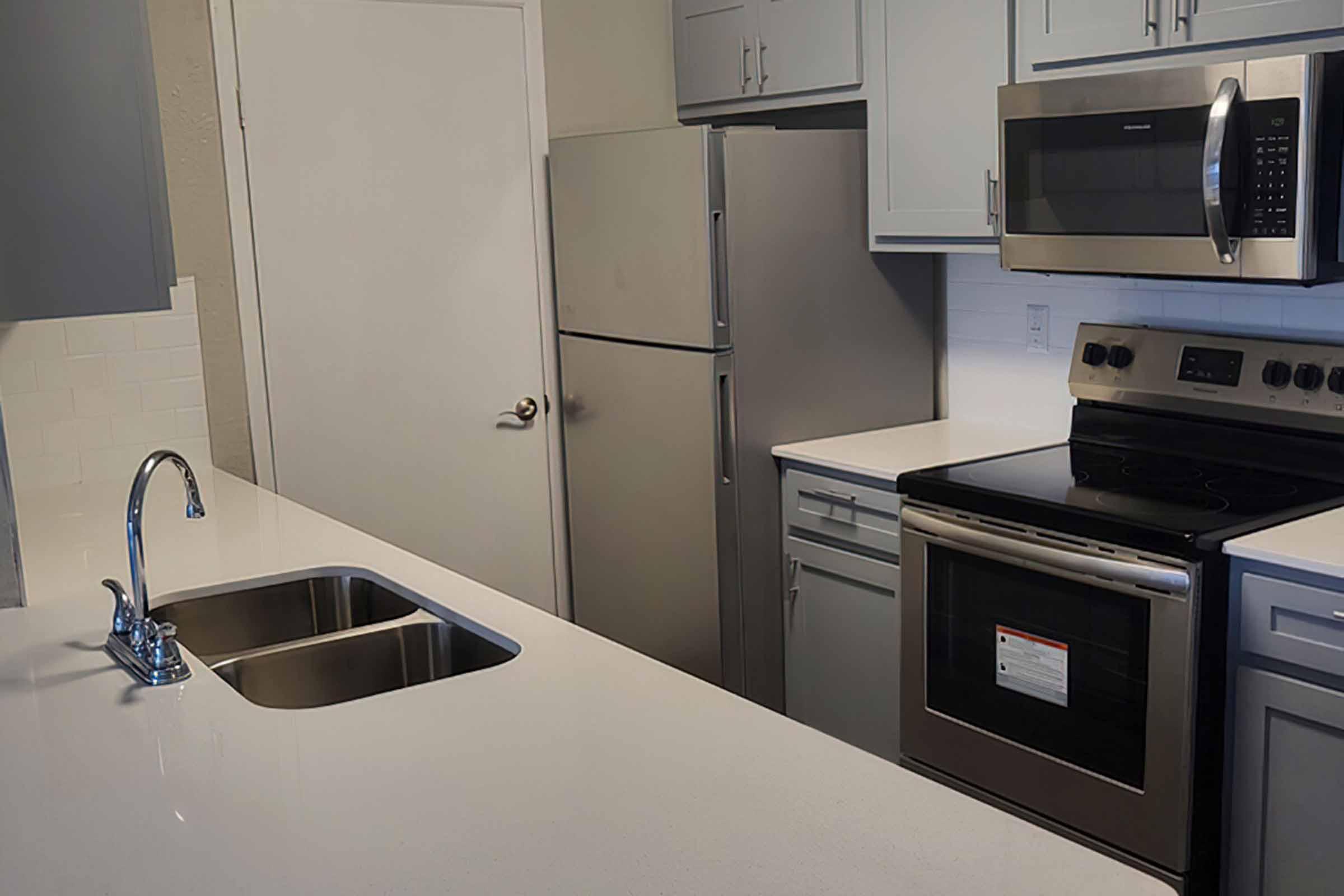 a stove top oven sitting inside of a kitchen