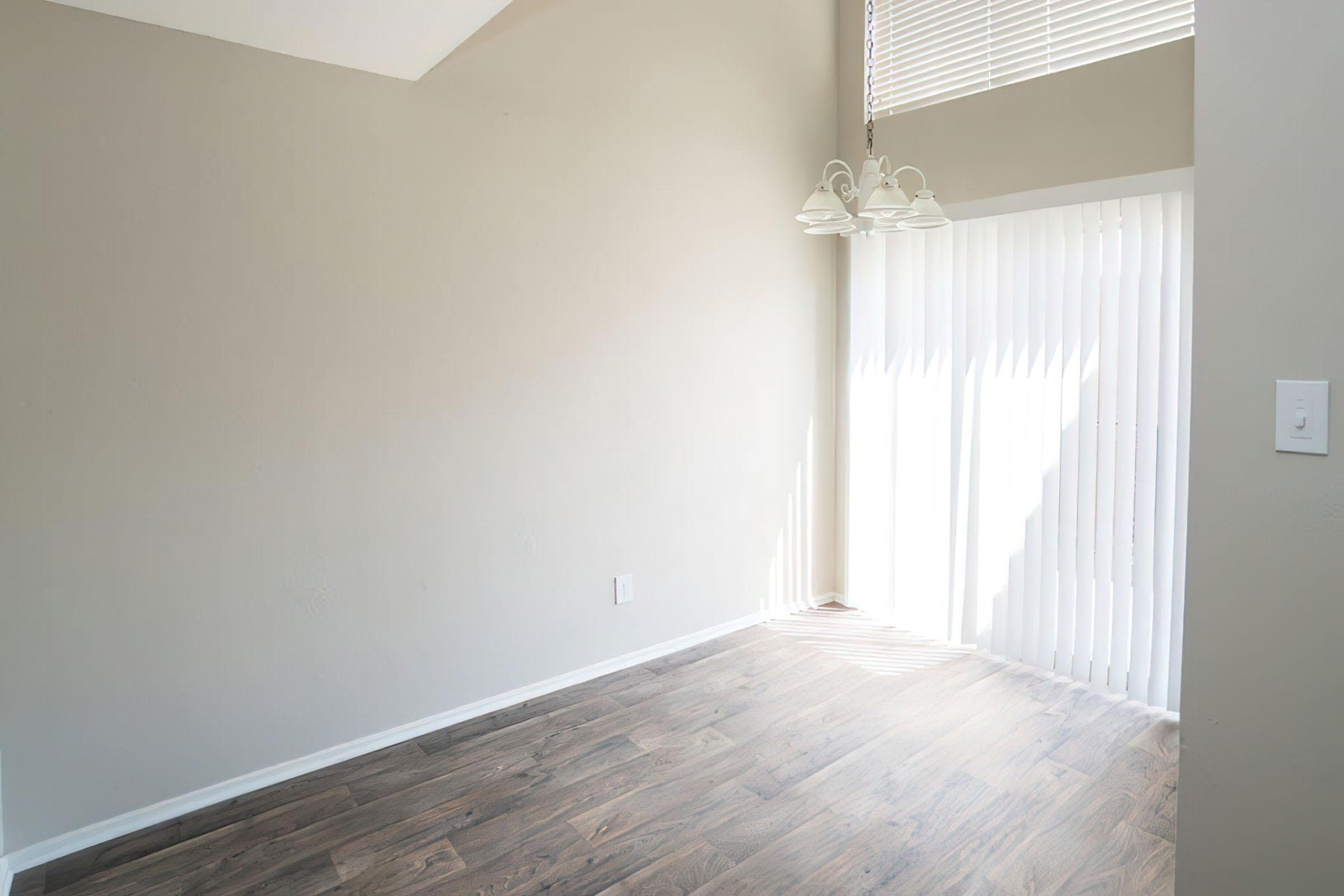 a bedroom with a wooden floor