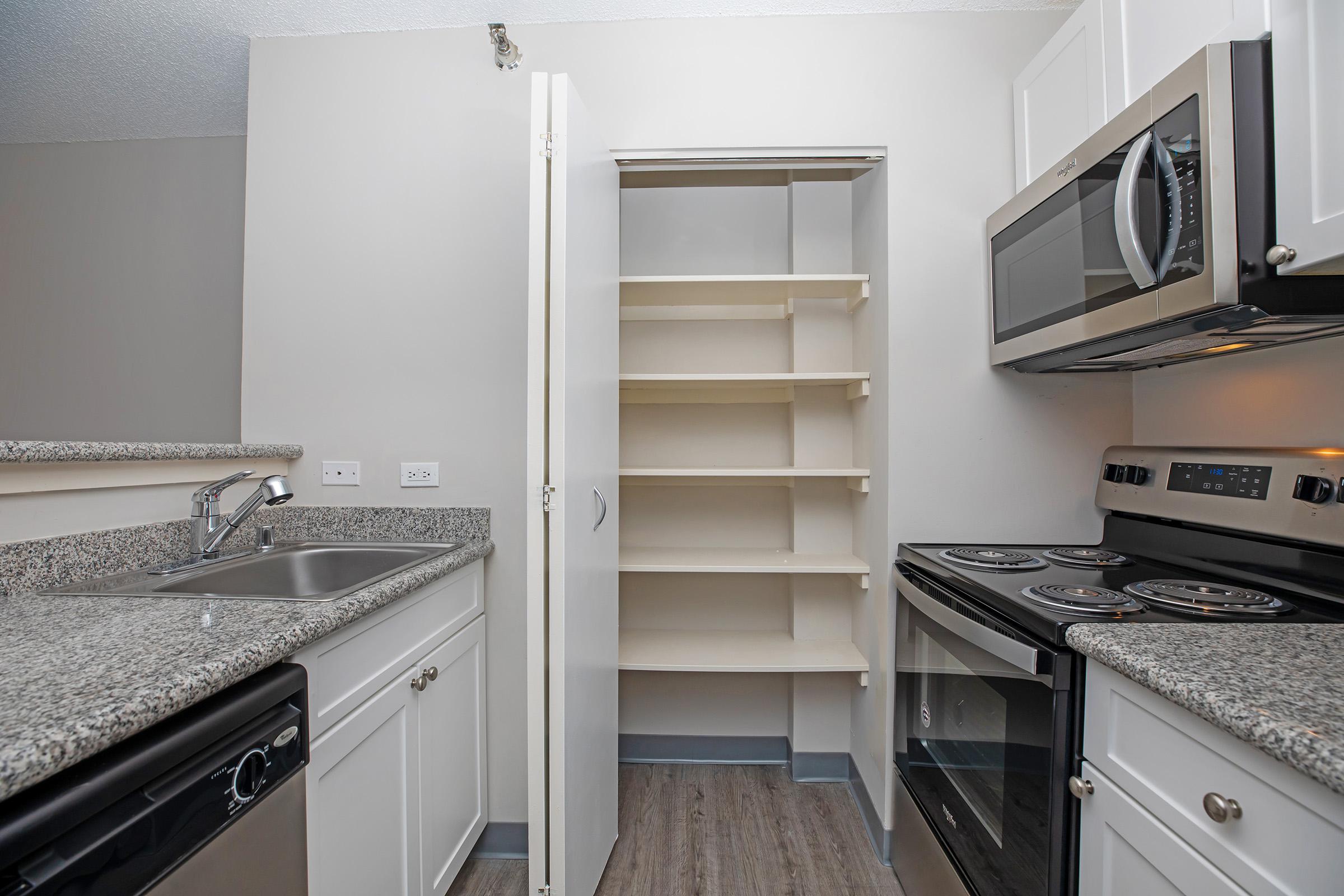 a stove top oven sitting inside of a kitchen