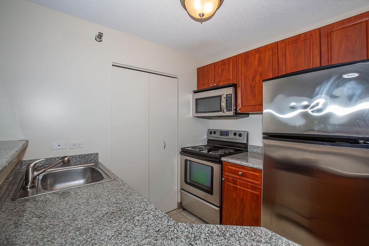 a kitchen with stainless steel appliances and wooden cabinets