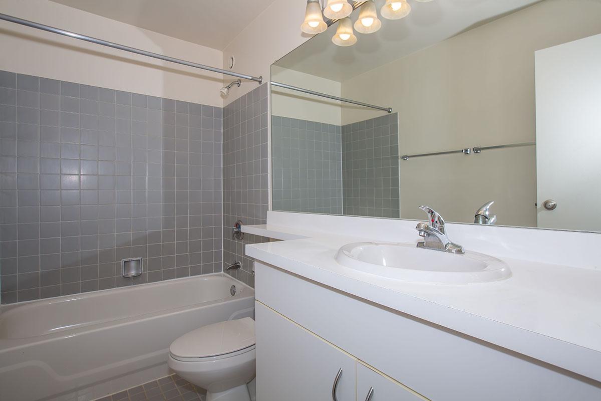 a large white tub sitting next to a sink