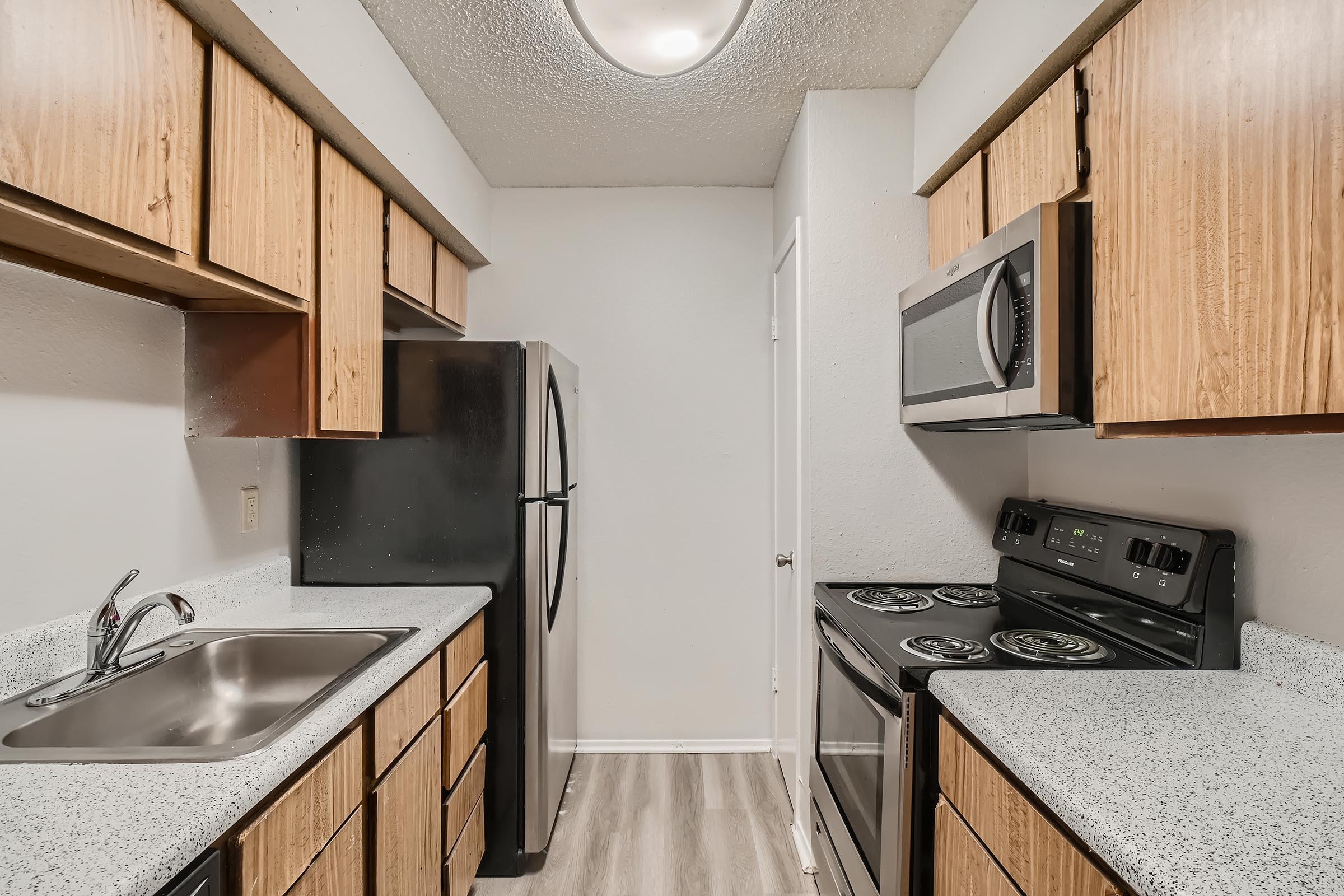 An apartment kitchen with stainless steel appliances at Rise North Arlington.