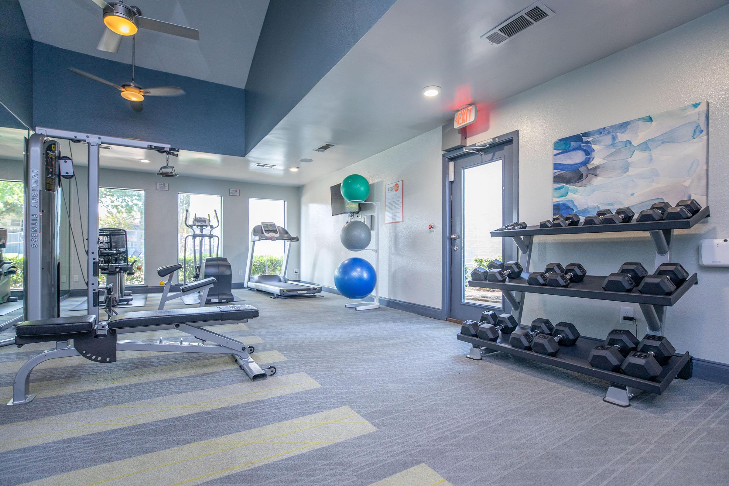 The modern fitness center at Rise North Arlington with workout equipment.