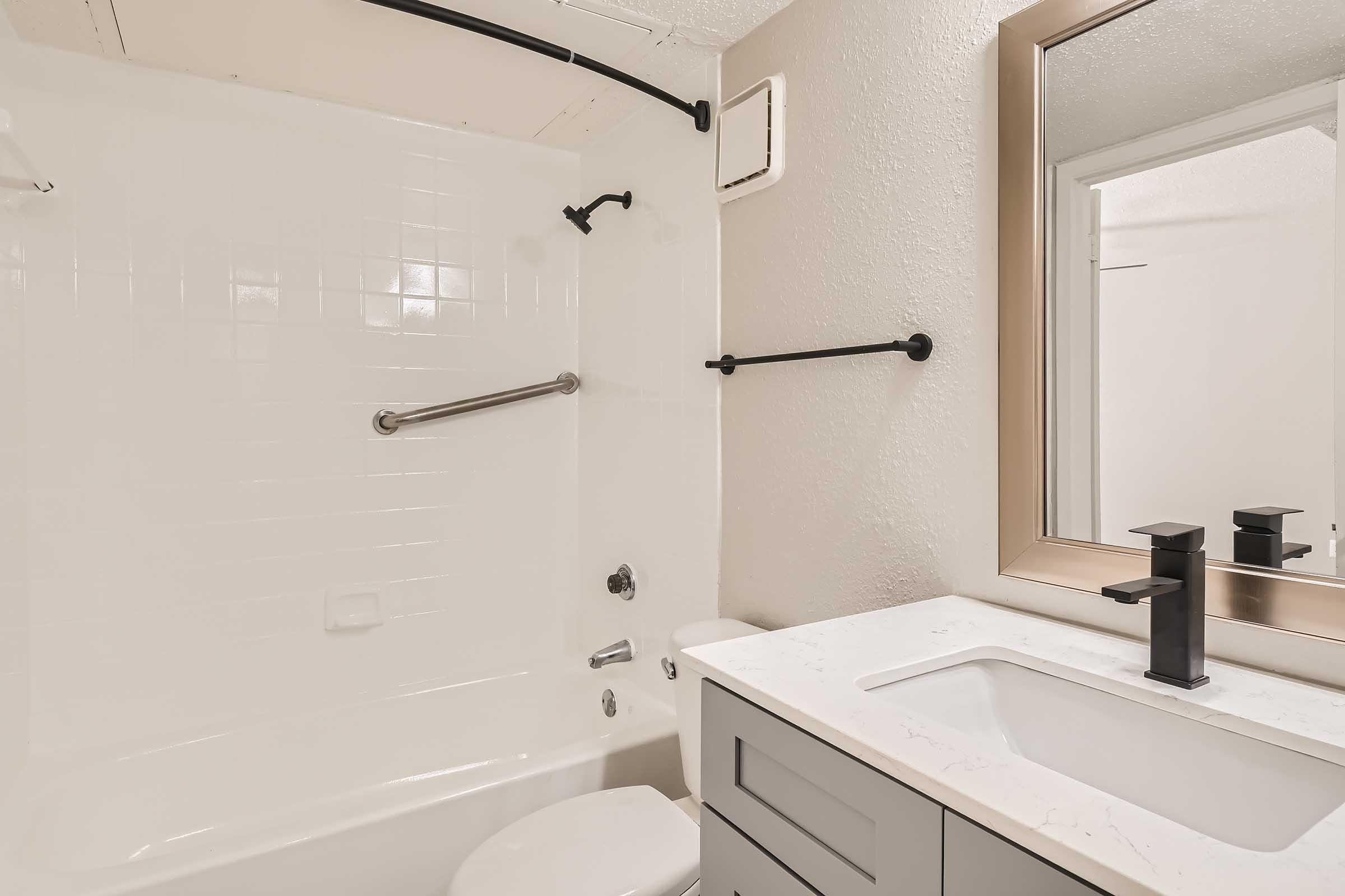 An apartment bathroom with a tub and shower at Rise North Arlington.