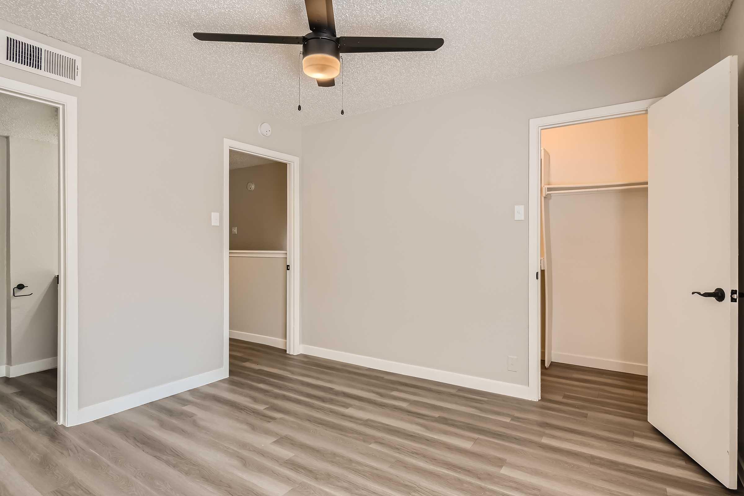 A large apartment bedroom with a closet at Rise North Arlington.