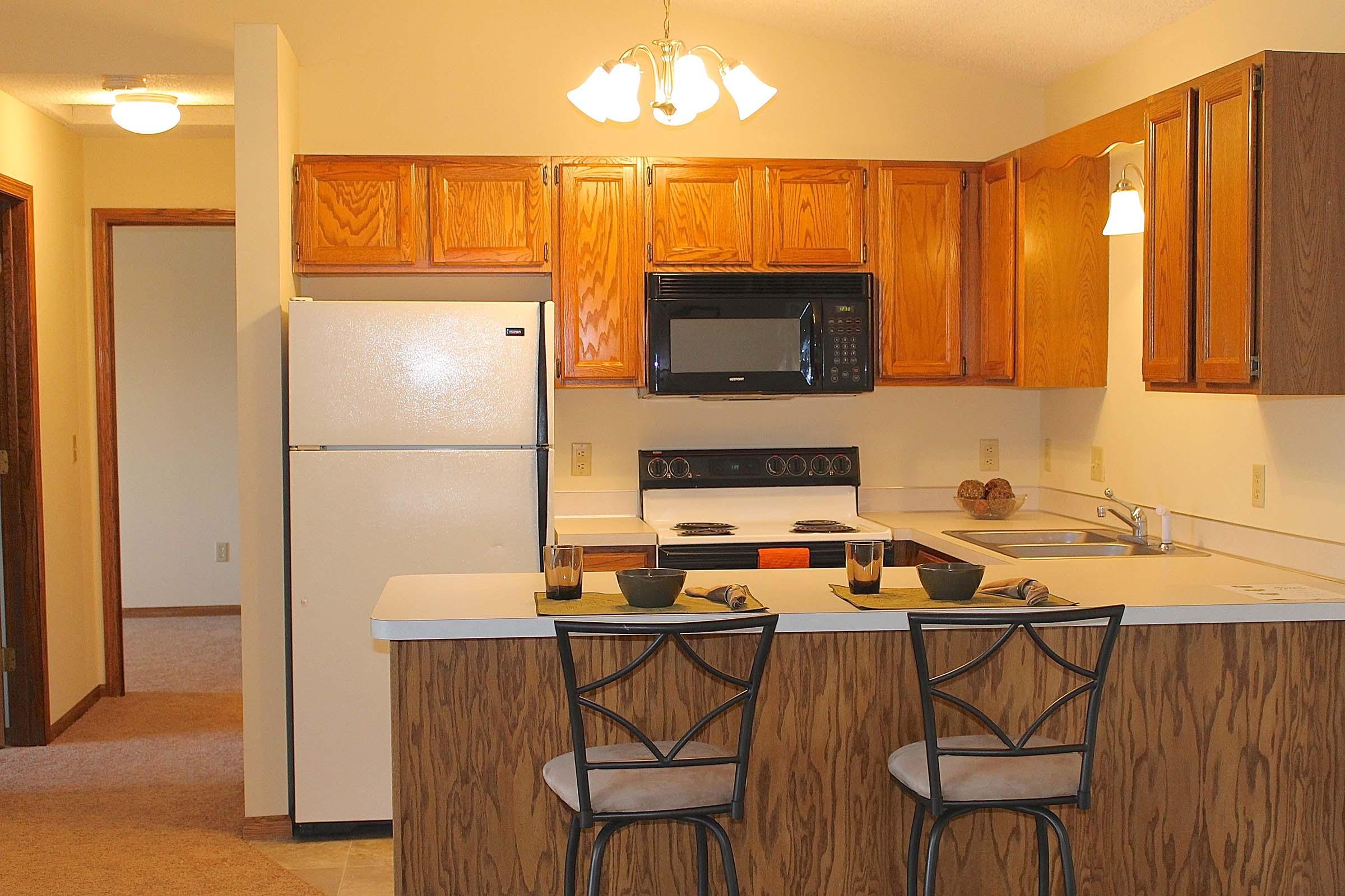 a kitchen with a stove top oven sitting inside of a room