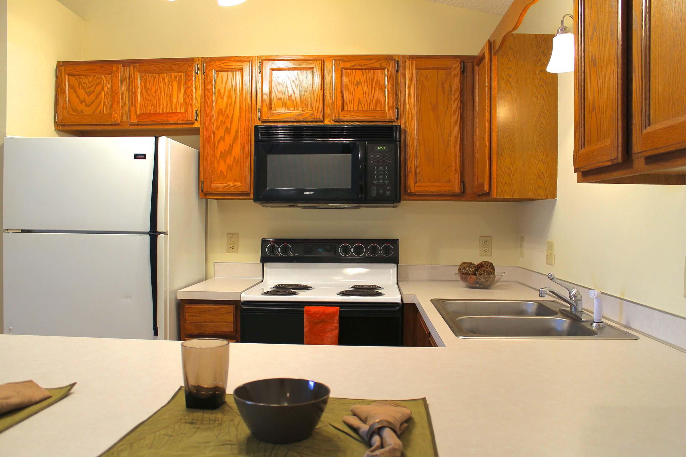 a stove top oven sitting inside of a kitchen