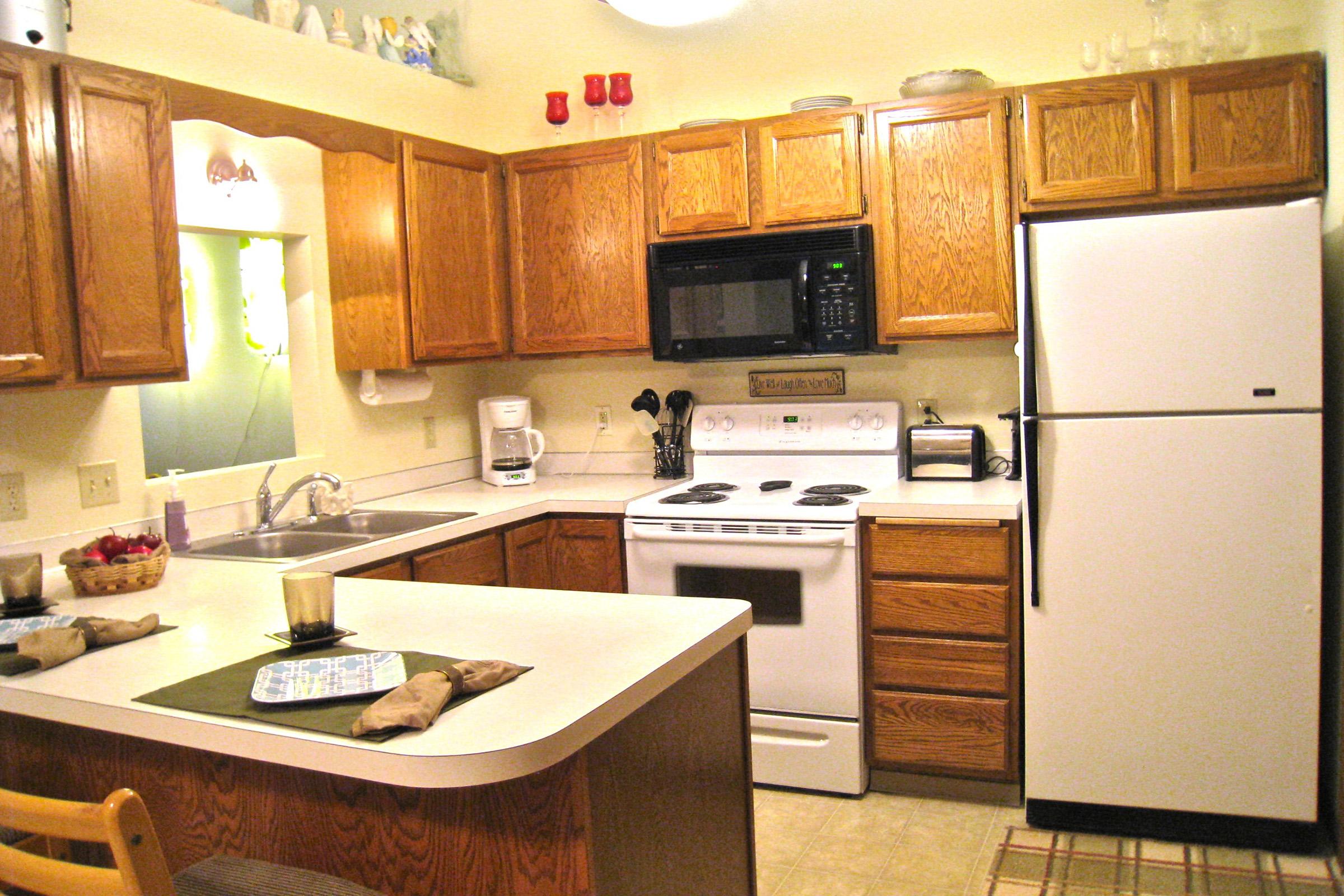 a kitchen with a stove a sink and a microwave