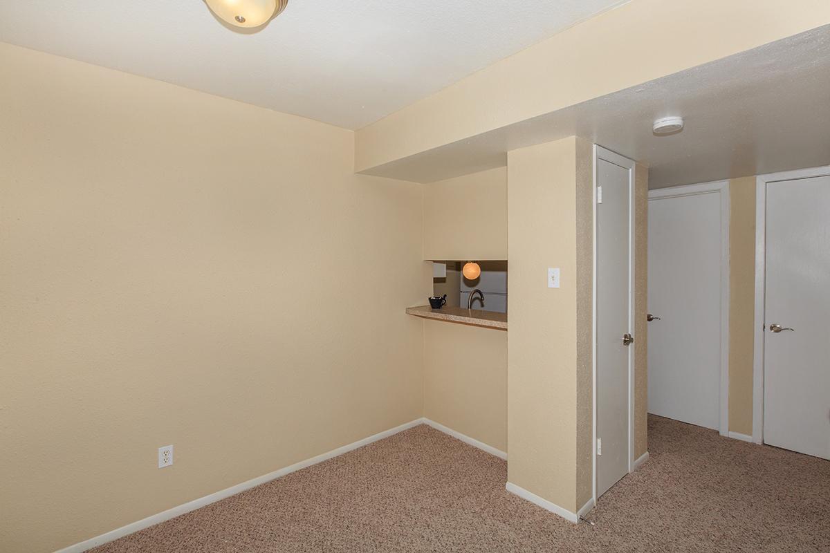 a large empty room with a sink and a mirror