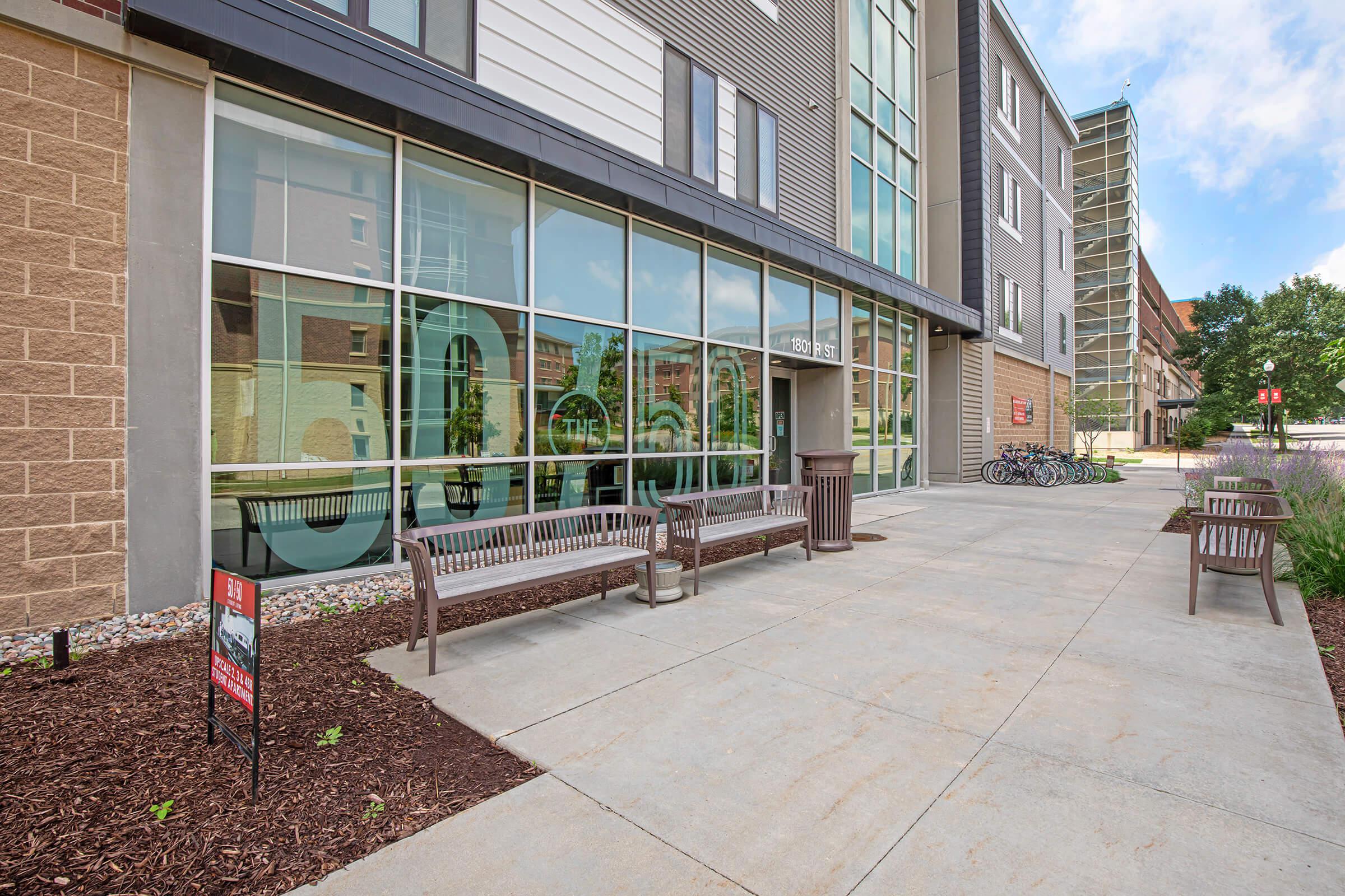 a bench in front of a brick building