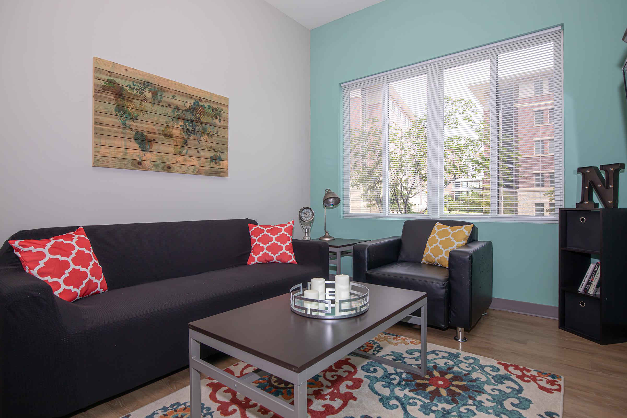 a living room filled with furniture and a rug