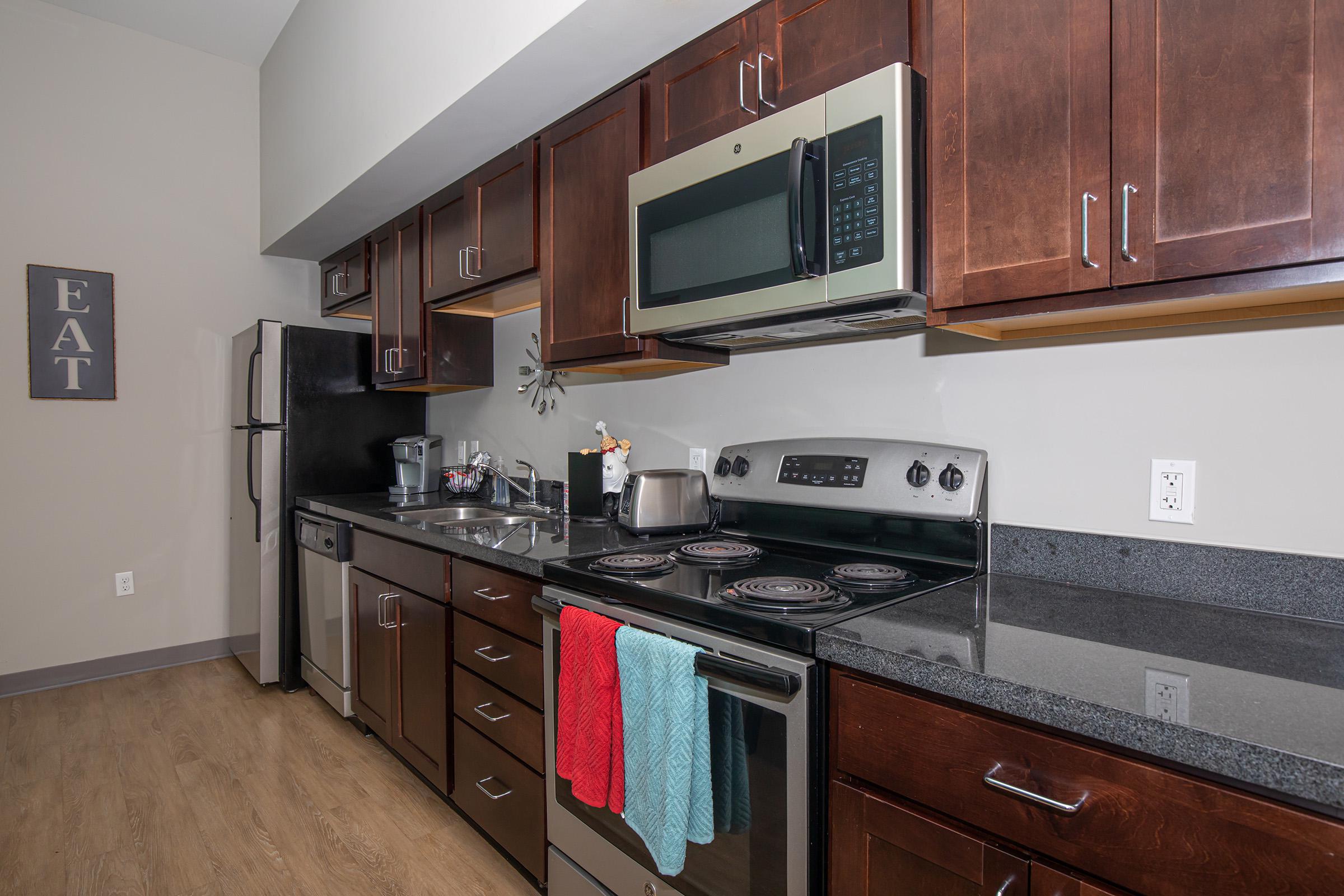 a kitchen with stainless steel appliances and wooden cabinets