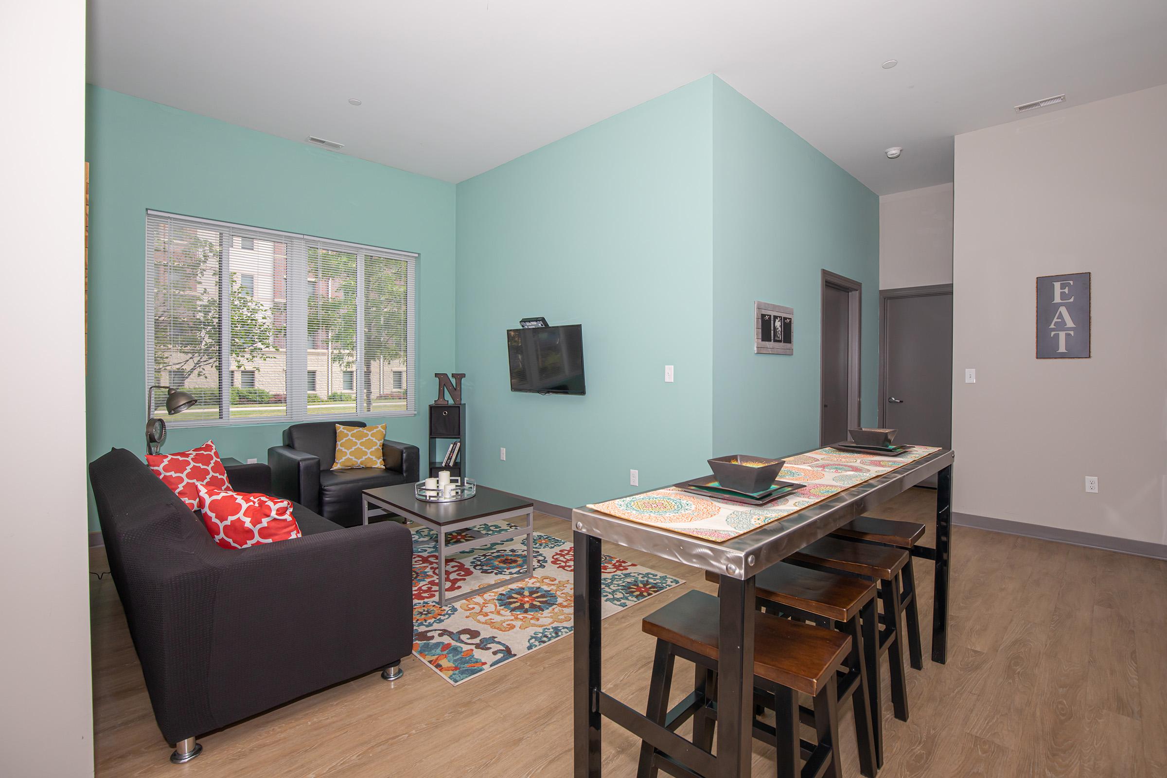 a living room filled with furniture and a table