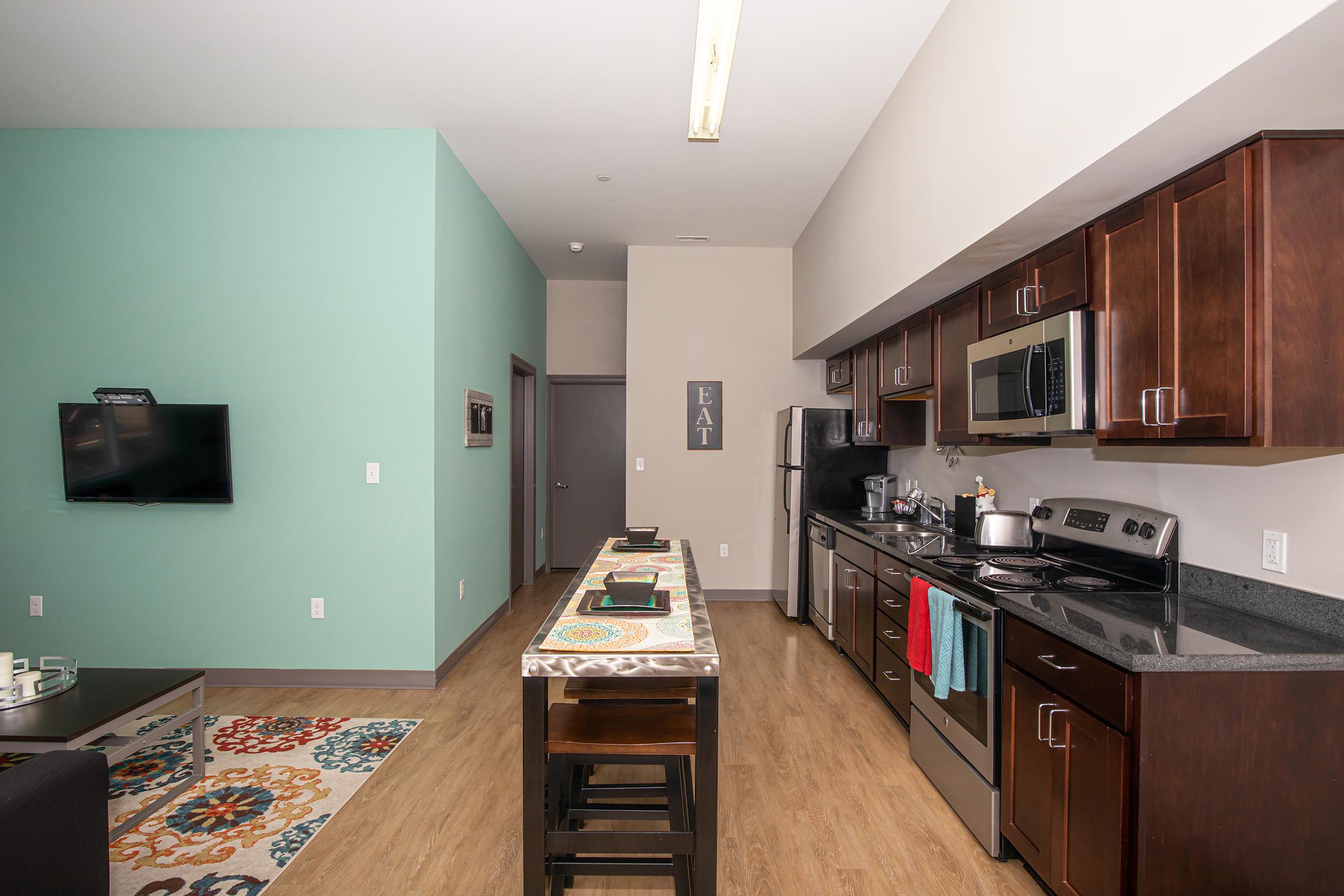 a kitchen with a stove and a refrigerator