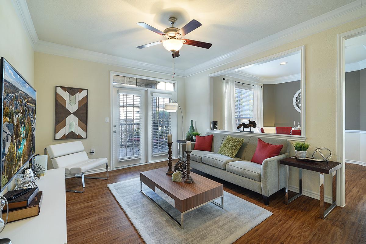 a living room filled with furniture and a large window