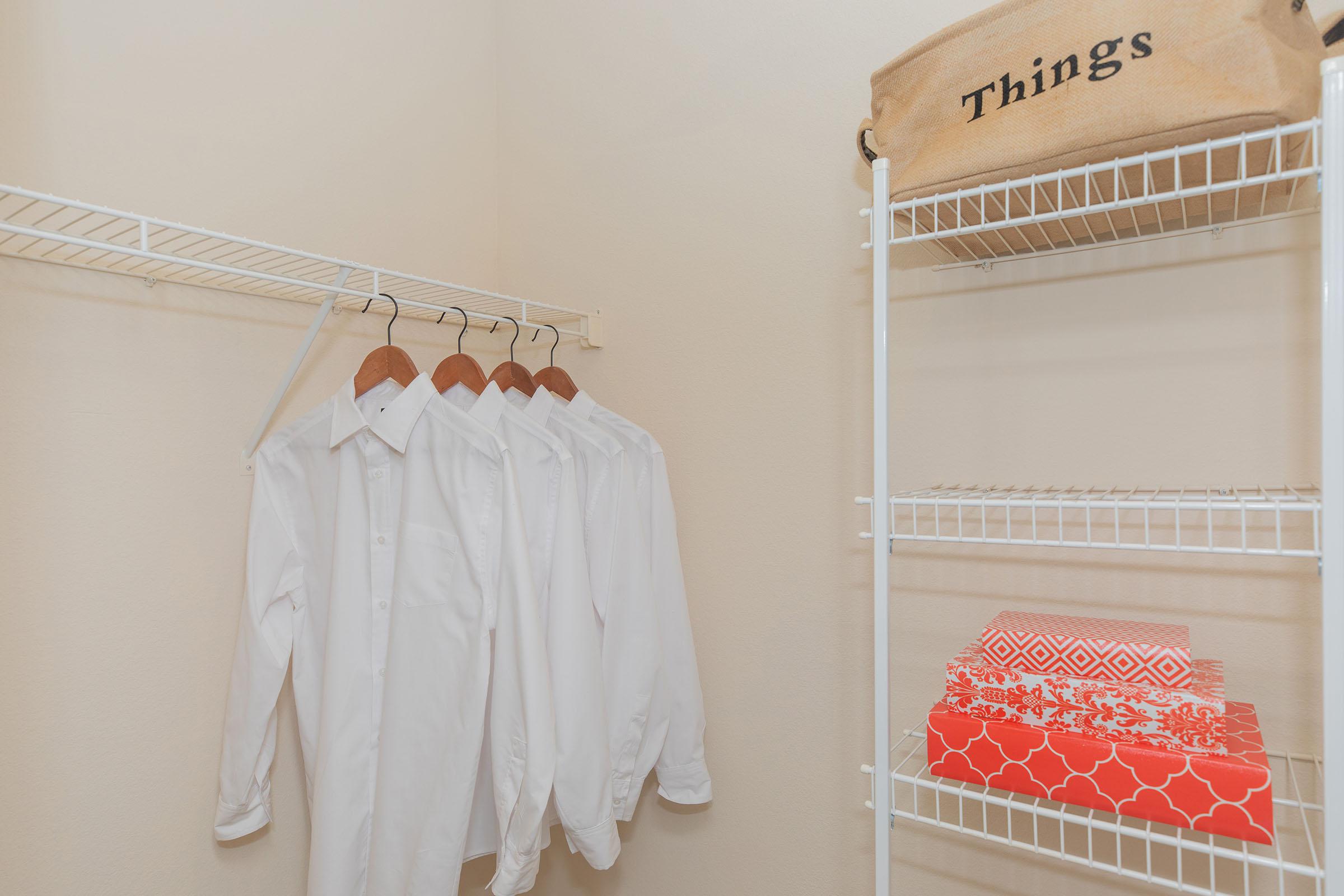 furnished walk-in closet with robes