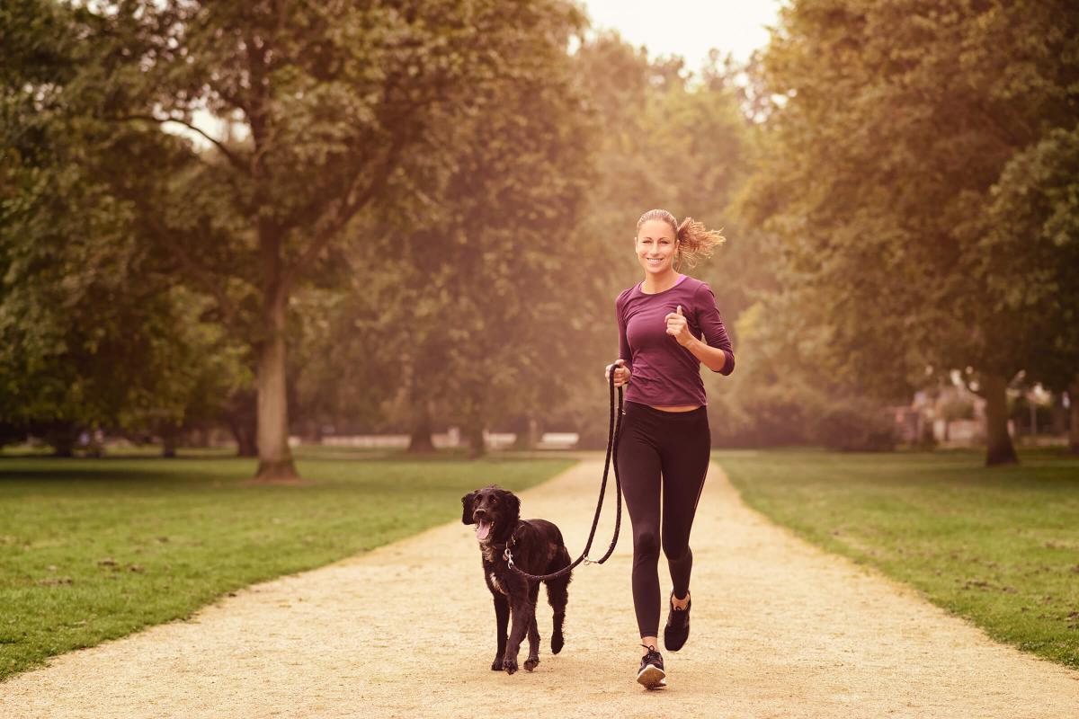Healthy Woman Jogging in the Park with her Dog iStock-488515352.jpg
