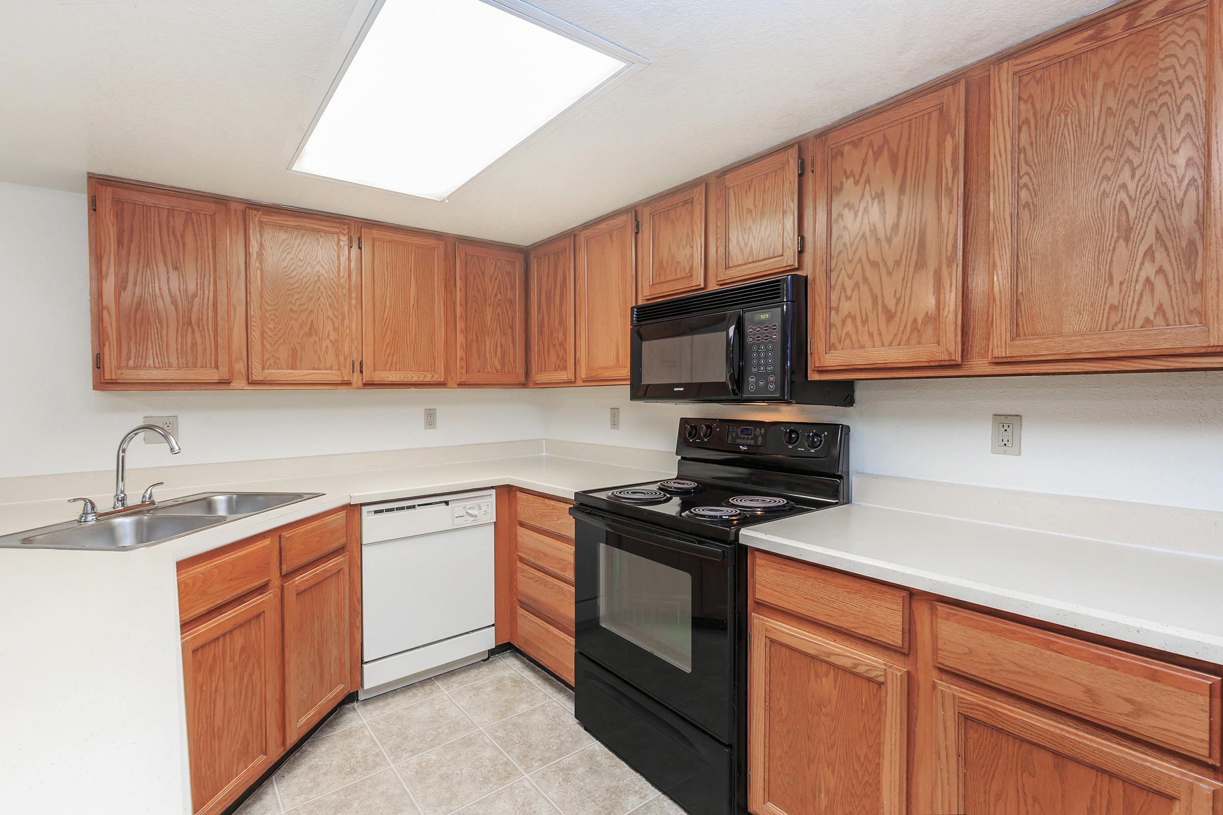 a kitchen with stainless steel appliances and wooden cabinets