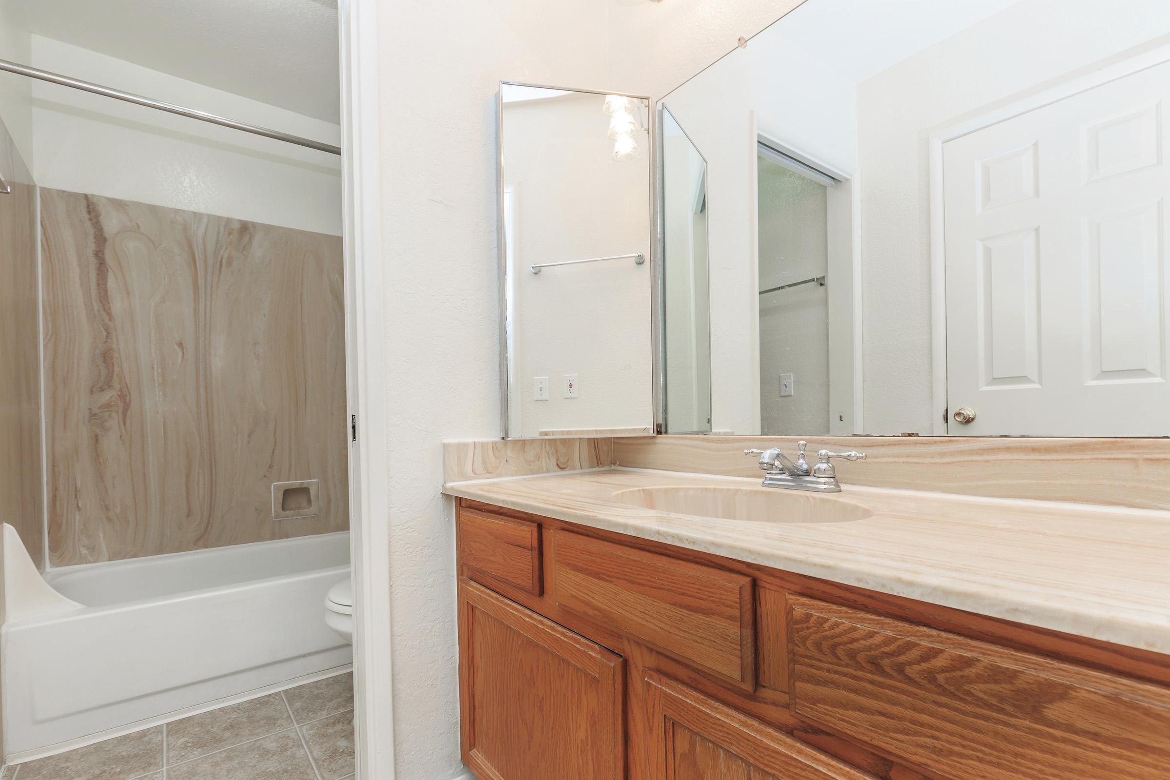 a white tub sitting next to a sink