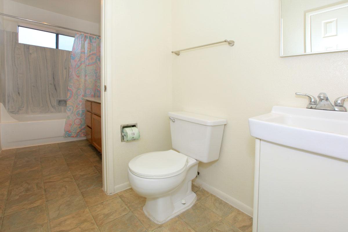 a white tub sitting next to a sink