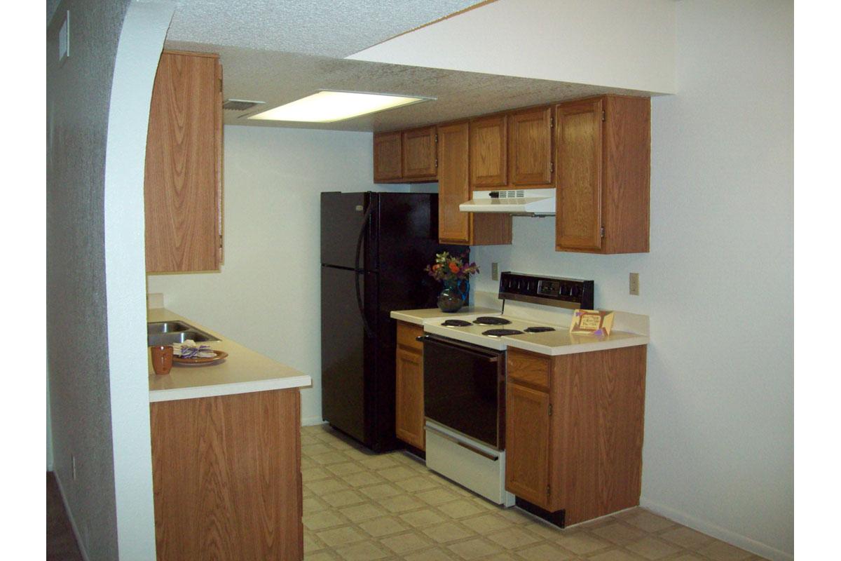 a kitchen with a stove sink and refrigerator