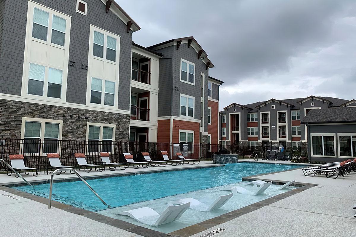 a large pool of water in front of a house