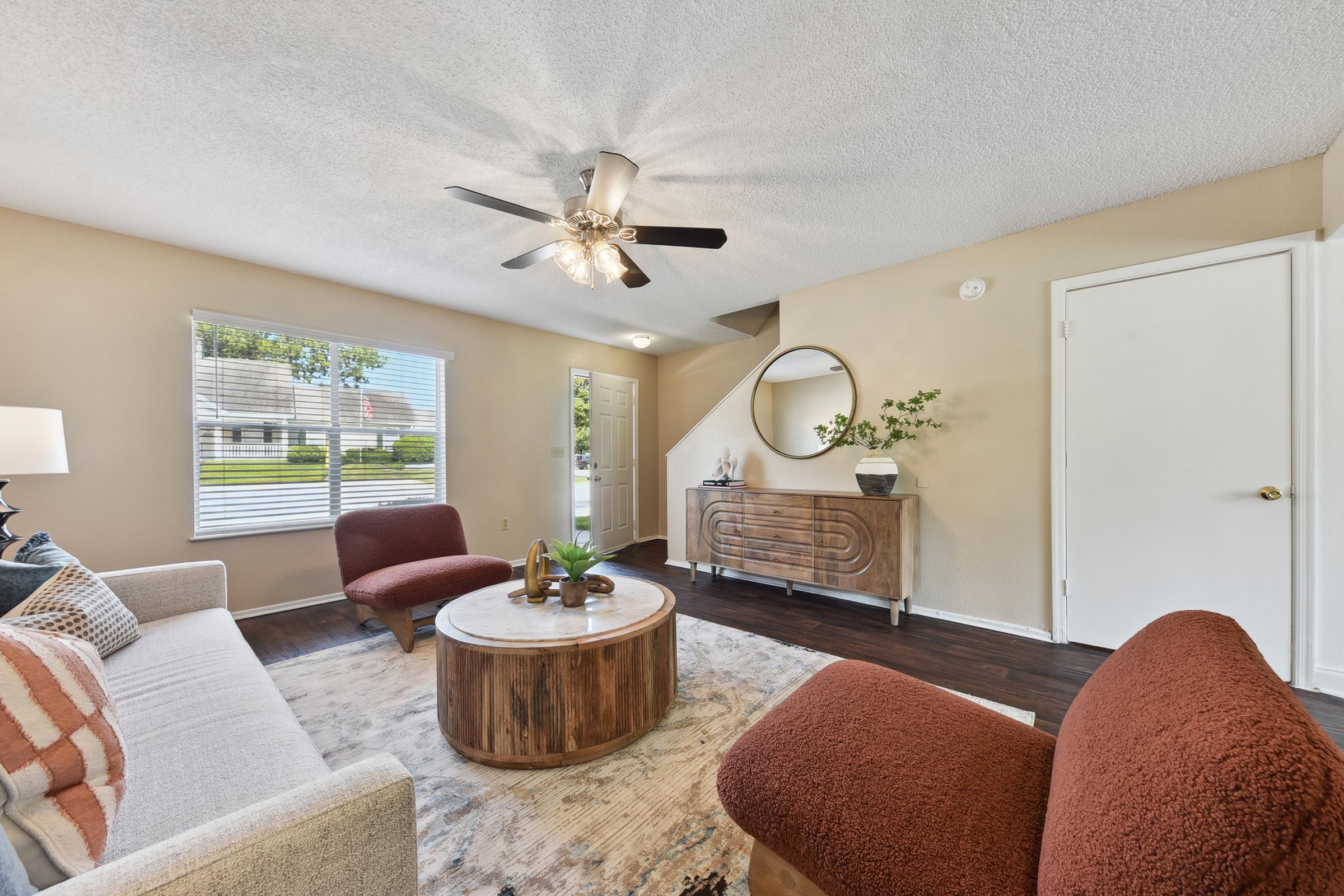 a living room filled with furniture and a flat screen tv