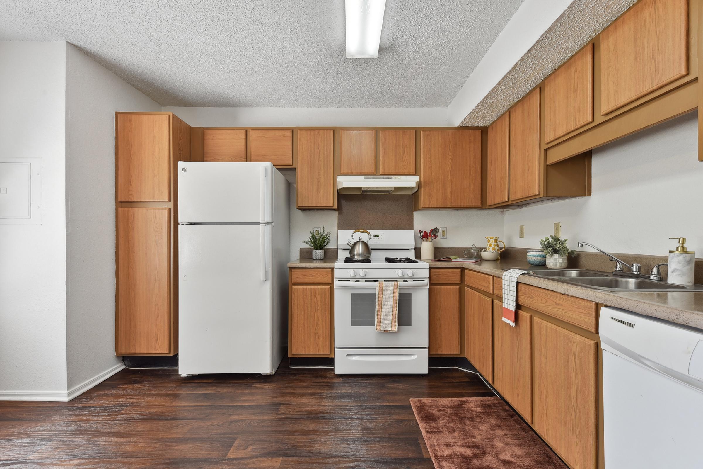 a kitchen with stainless steel appliances and wooden cabinets