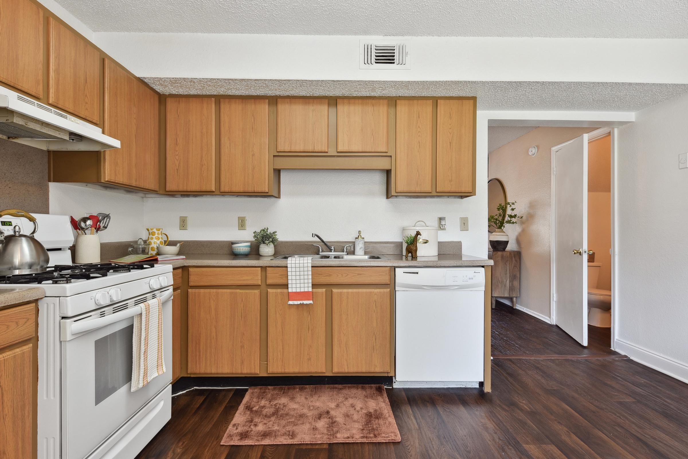 a kitchen with stainless steel appliances and wooden cabinets