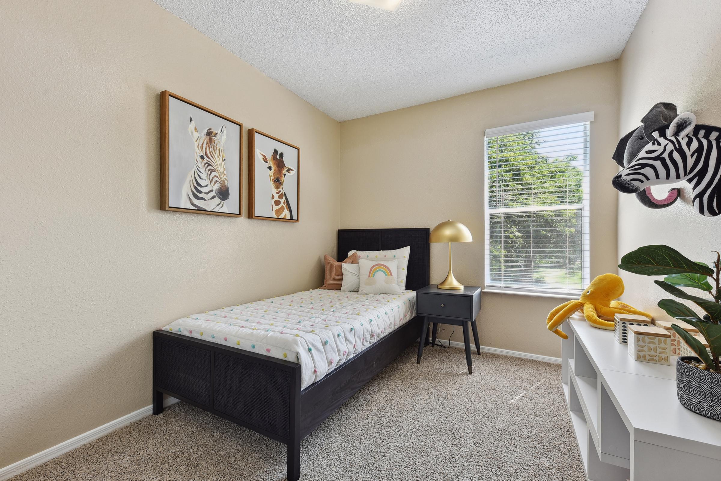 a bedroom with a bed and desk in a room