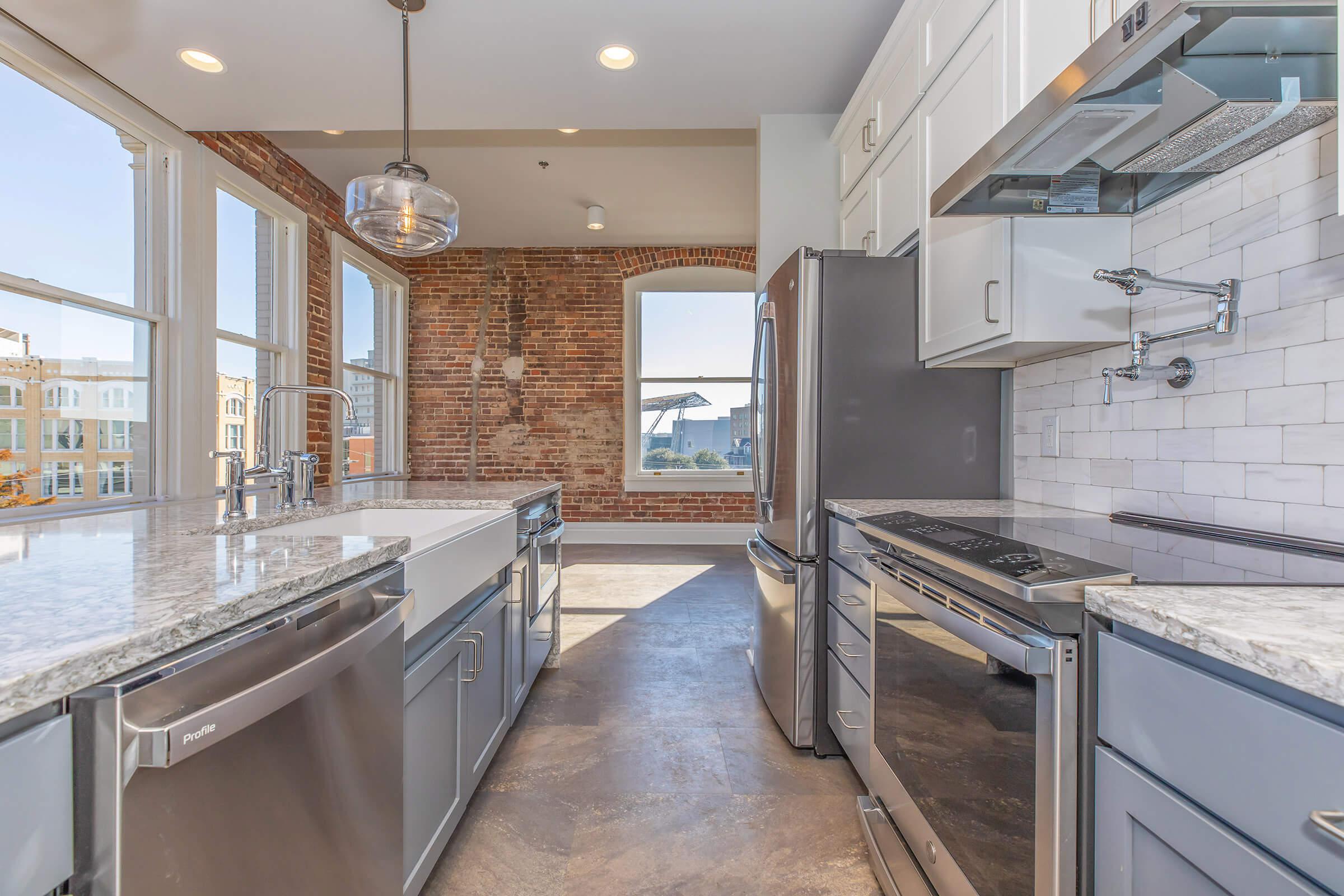 a large kitchen with stainless steel appliances