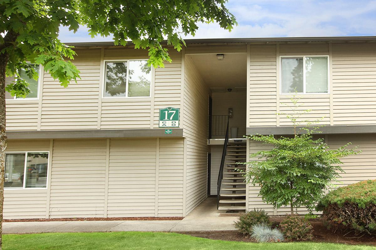 a house with a lawn in front of a building